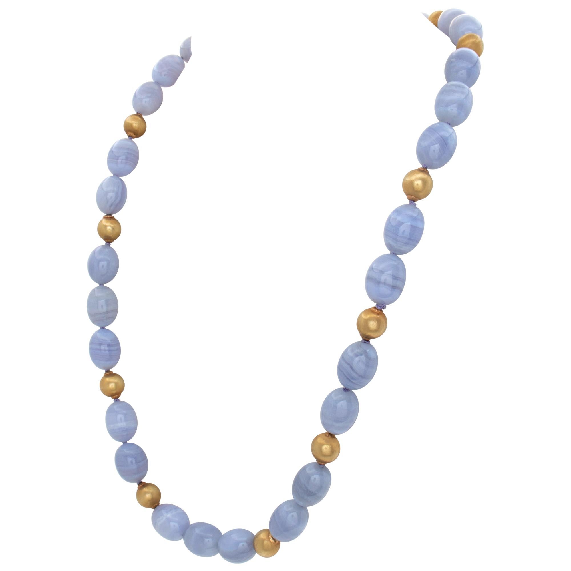 Blue lace chalcedony oval stone bead necklace with 12 18k gold bead station accents. Length 24 inches.
