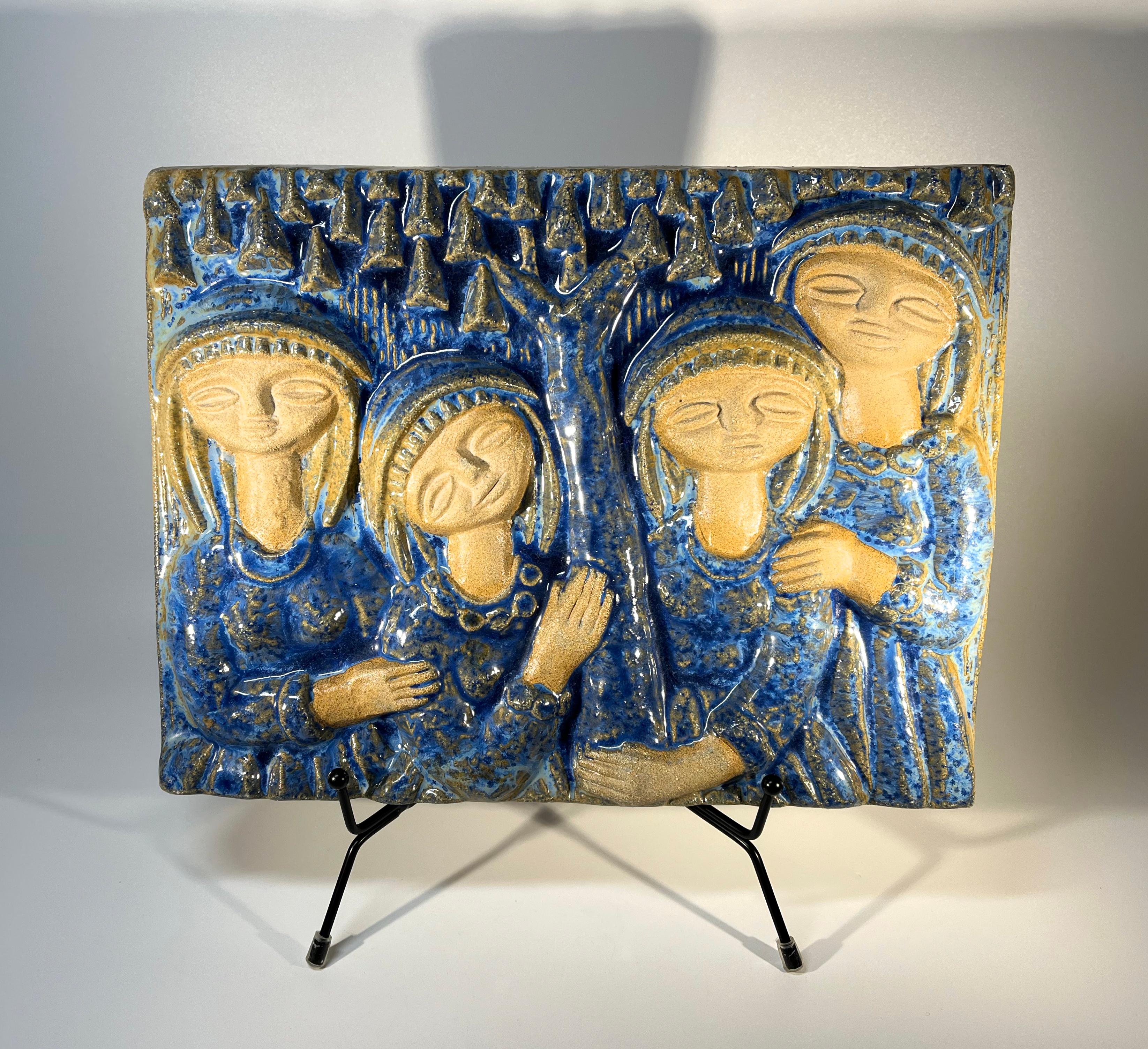 Four Soulful Women In Blue wall plaque, by Marianne Starck for Michael Andersen, Denmark 
Superb varying degrees of cobalt blue glaze over stoneware
Stamped MS, Three Herrings mark and #5842 on reverse
Width 11 inch, Height 9 inch, Depth 1