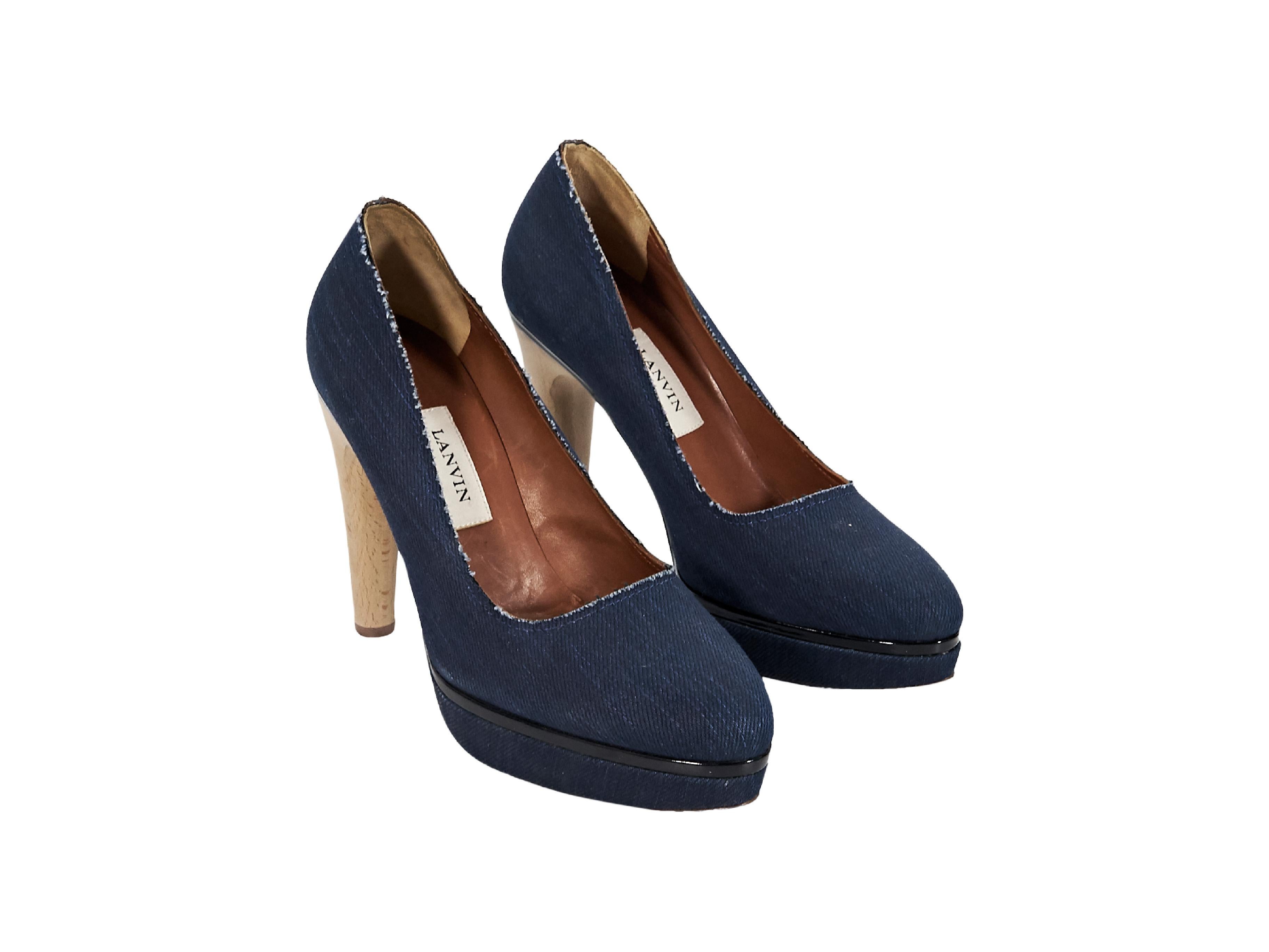 Product details:  Blue denim platform pumps by Lanvin.  Trimmed with black patent leather.  Round toe.  Wooden heel.  Slip-on style.  4.75