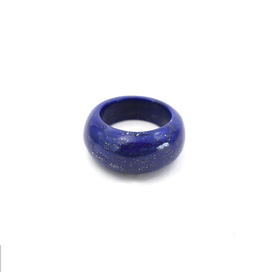 The Blue Lapis Cocktail Ring is a breathtaking and bold statement piece that showcases the natural beauty of lapis lazuli in a sophisticated and modern design. This ring features a large, smooth, and finely polished lapis lazuli that mesmerizes with