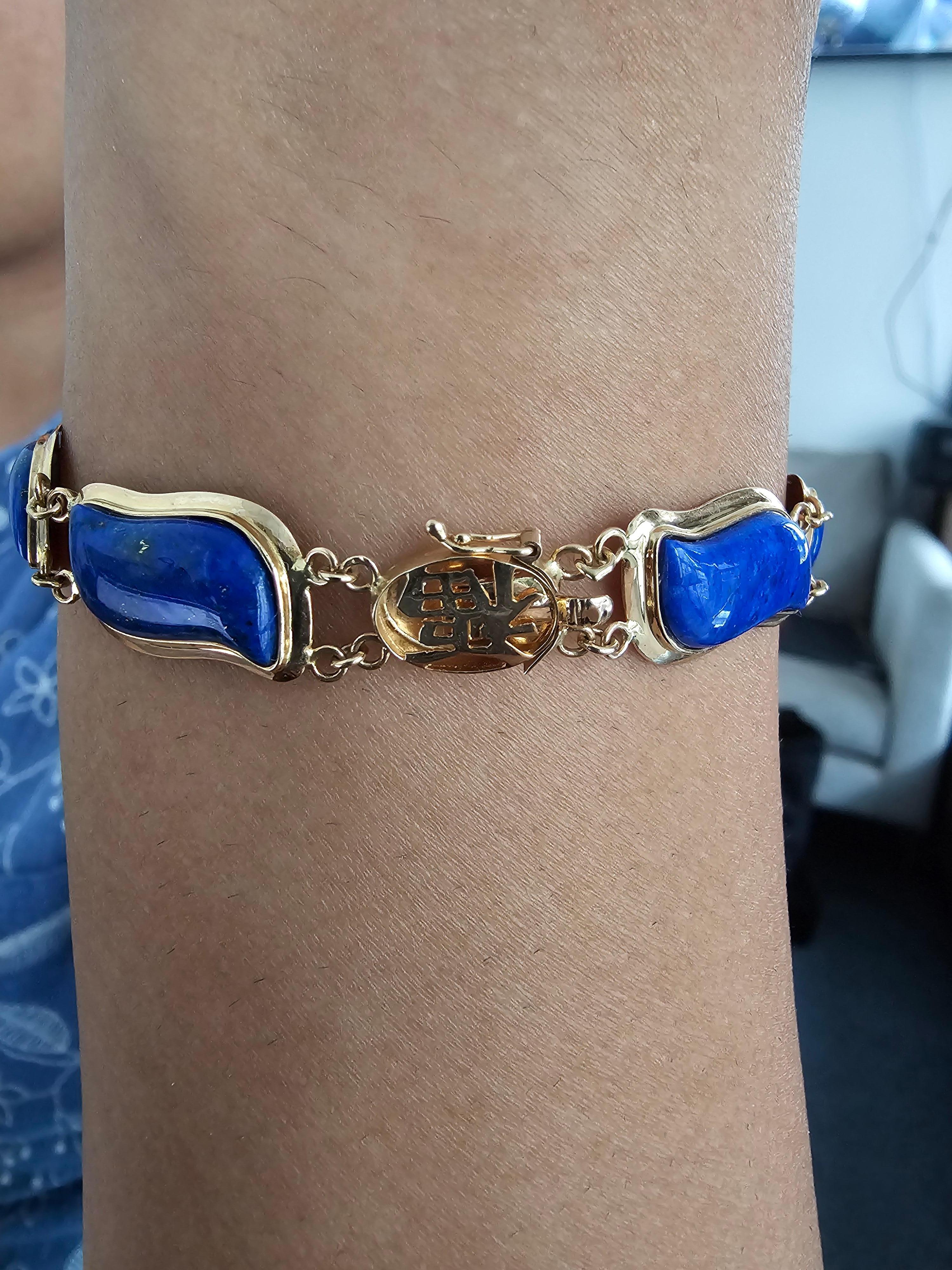 Blue Lapis Lazuli Bracelet Aurora Double Chained with 14K Solid Yellow Gold links and clasp. 

Using the natural Palette of Lapis Lazuli, and contrasting it with yellow gold, we created a bracelet that mirrors the Aurora Borealis. We grappled Lapis