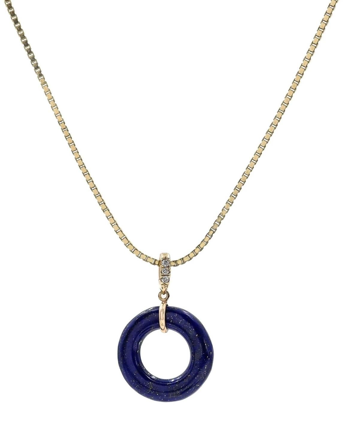 The Blue Lapis Open Space Round Pendant with a diamond-accented bale is a truly remarkable and exquisite piece of jewelry that seamlessly blends the captivating allure of lapis lazuli with the brilliance of diamonds. This pendant features an open