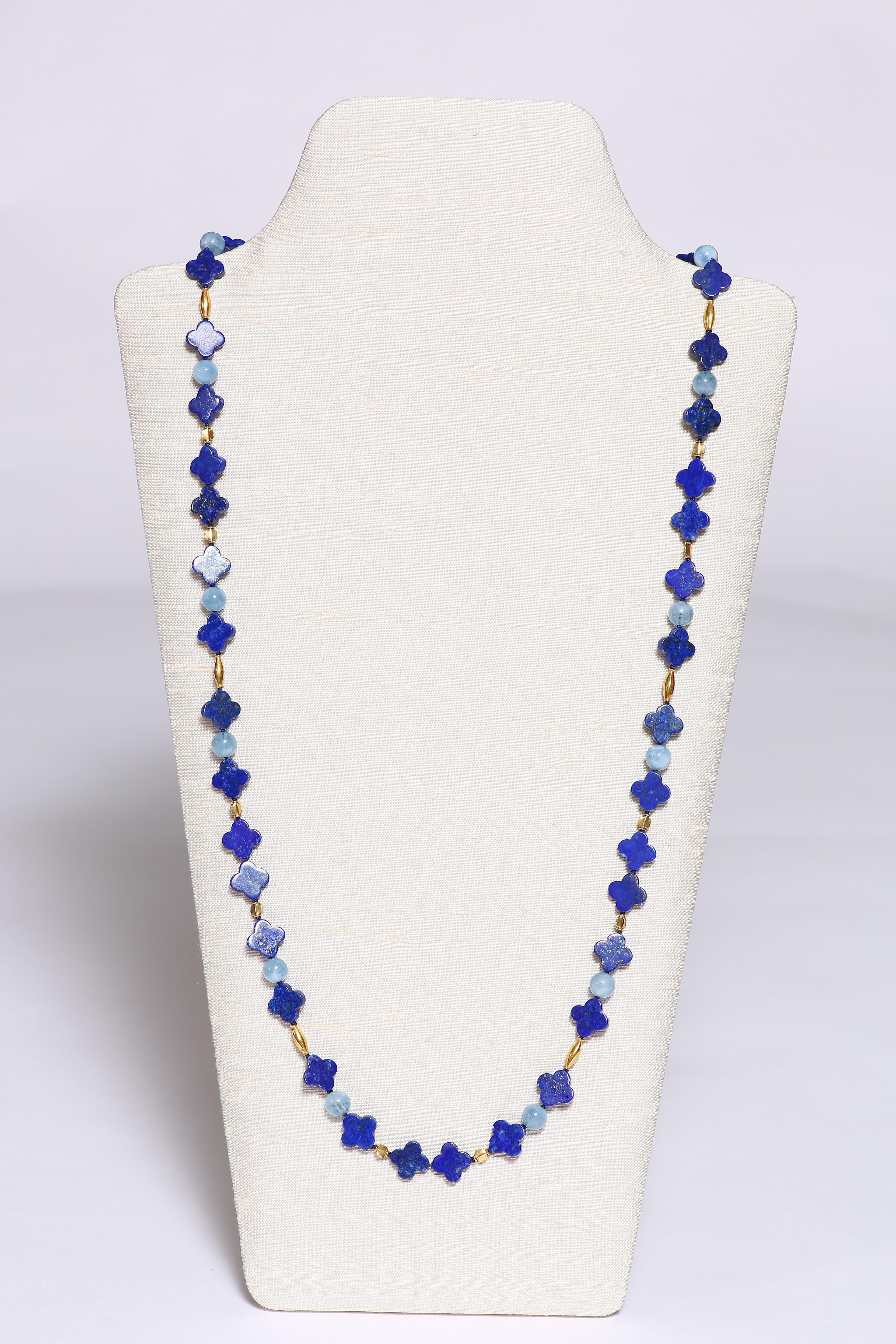 The vibrant blue colour of the quatrafoil lapiz beads are accentuated by round soft colour auuamarine beads and spaced by 18k gold faceted beads. The charming necklace at 37