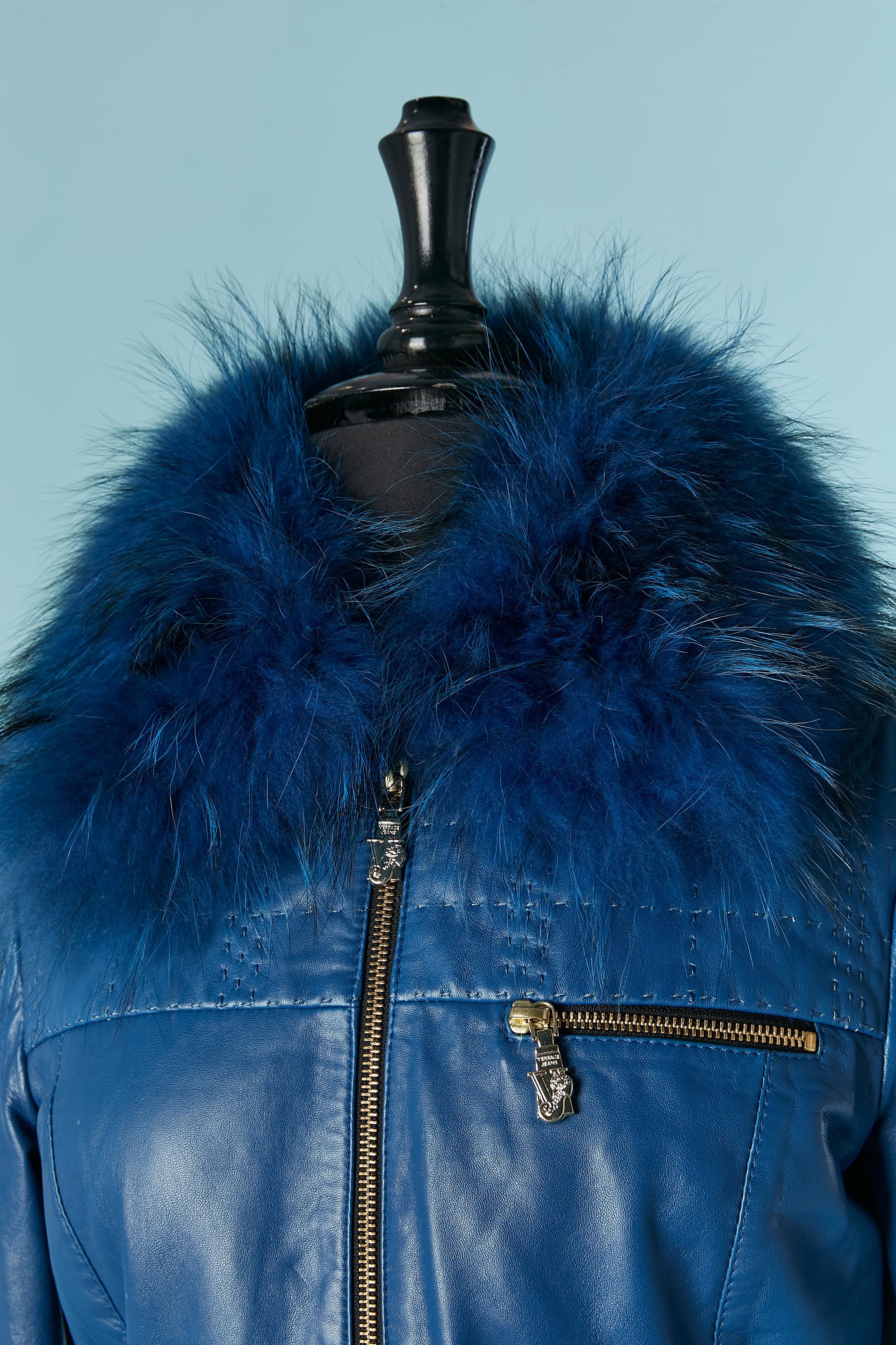Blue leather jacket with detachable racoon collar and belt with plexi  buckle and snap closure . Polyester lining. Zip closure on the middle front with branded zip puller. Same on the breast pocket. Top-stitched sleeve and shoulder. 
SIZE 42 (It) 38