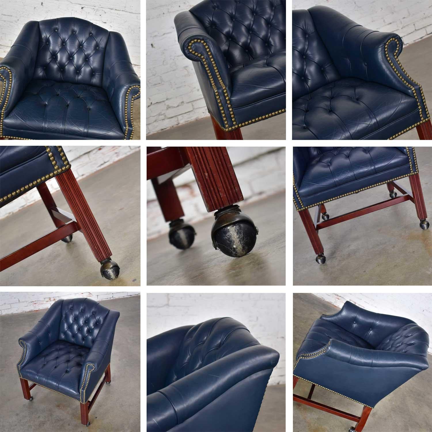 Handsome blue leather rolling Captain’s chair in a Campaign or Chippendale style game or tub chair on painted ball casters. In wonderful vintage condition. Age-appropriate condition with a few imperfections as one would expect with a vintage piece.