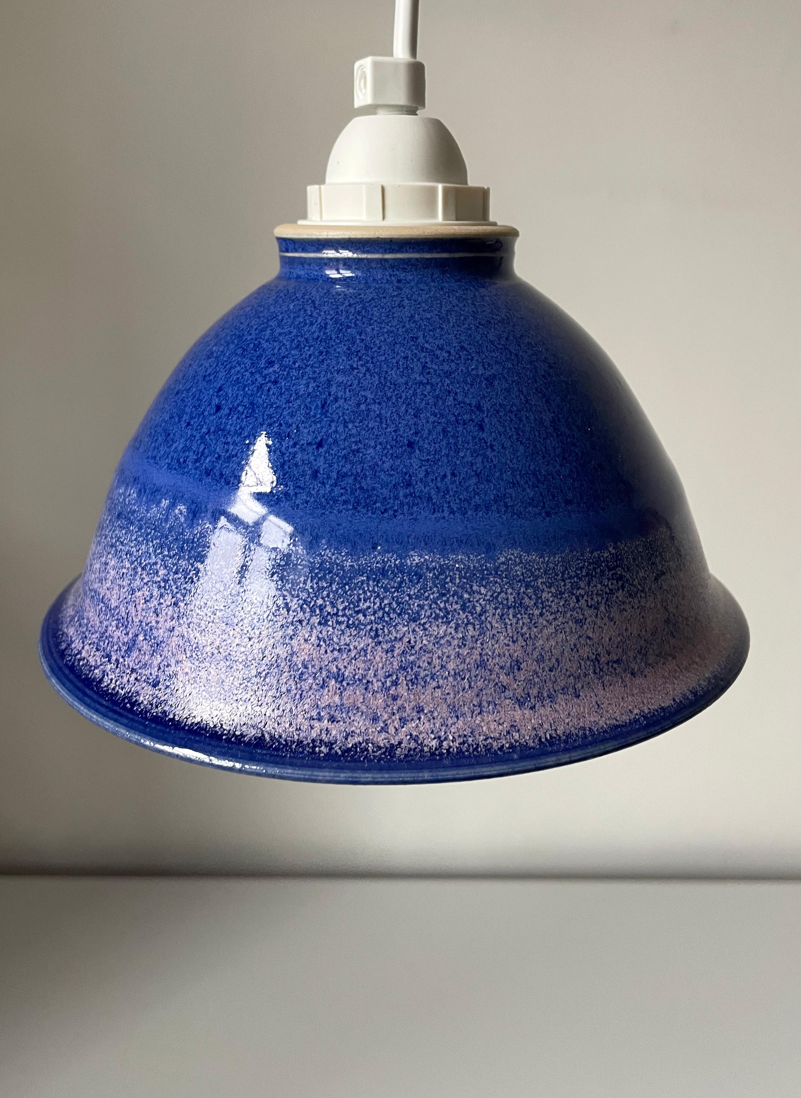 Scandinavian modern blue, lilac and rose colored ceramic pendant. Handmade soft shaped and shiny glazed nordic design piece. Blue glaze on the inside. Fitting for E27 bulb. Rewired and in beautiful vintage condition. 
Denmark, 1970s. 