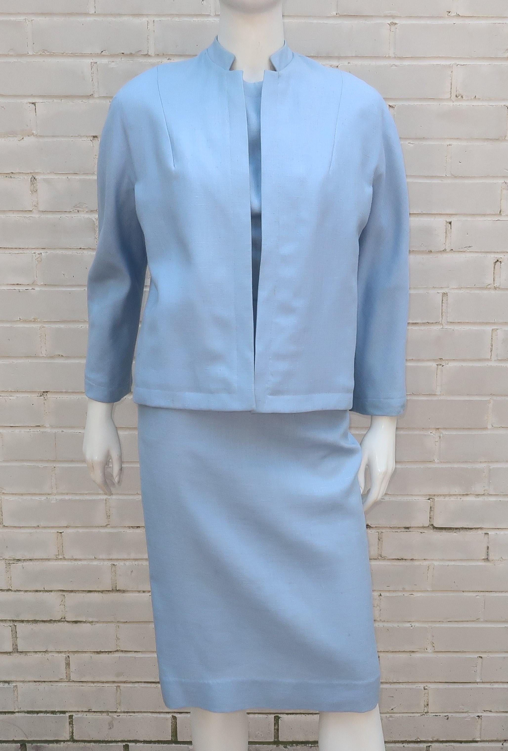 C.1960 pale blue linen dress and jacket ensemble with surprise beading at the interior lining of the jacket.  The form fitting dress has a 'wiggle' silhouette with a modified scoop back.  It zips and hooks at the back with a coordinating belt at the