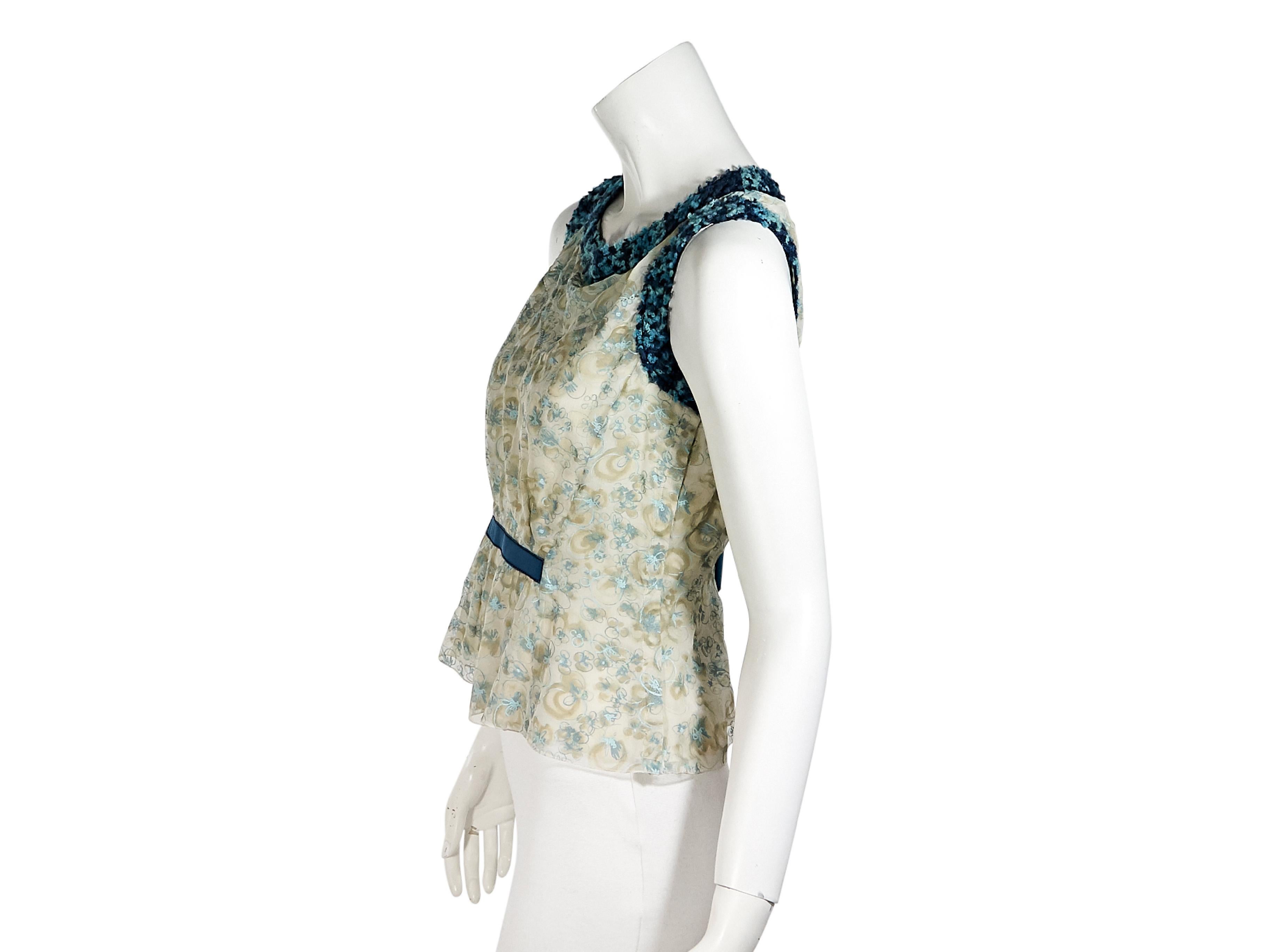 Product details:  Blue floral-printed silk blouse by Louis Vuitton.  Scoopneck.  Sleeveless.  Fitted bodice.  Bow back accent.  Pullover style.  33