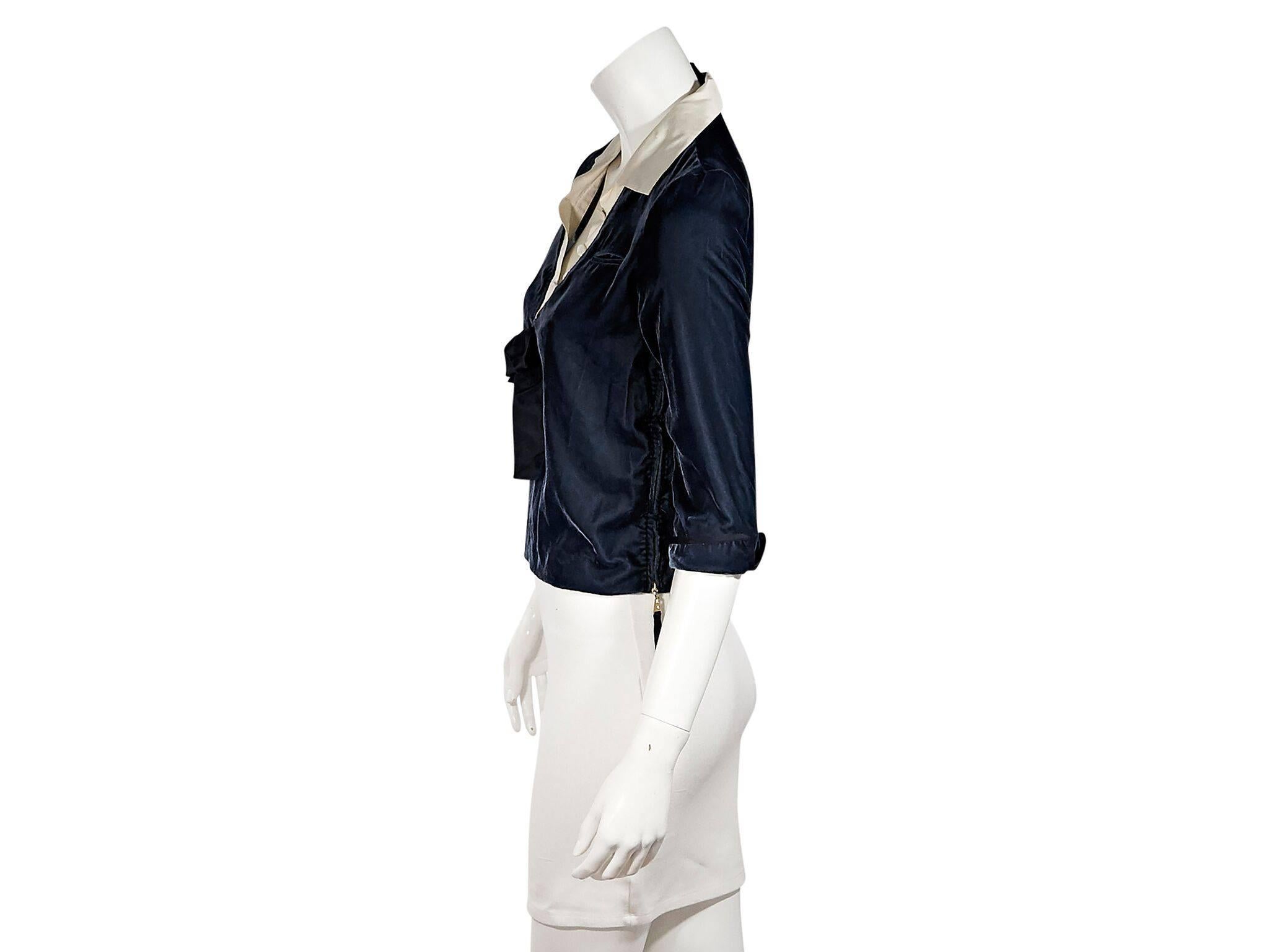 Product details:  Blue velvet top by Louis Vuitton.  Cream silk spread collar.  Button placket.  Elbow-length sleeves.  Rolle cuffs.  Besom chest pocket.  Side zipper details.  Pullover style.  36