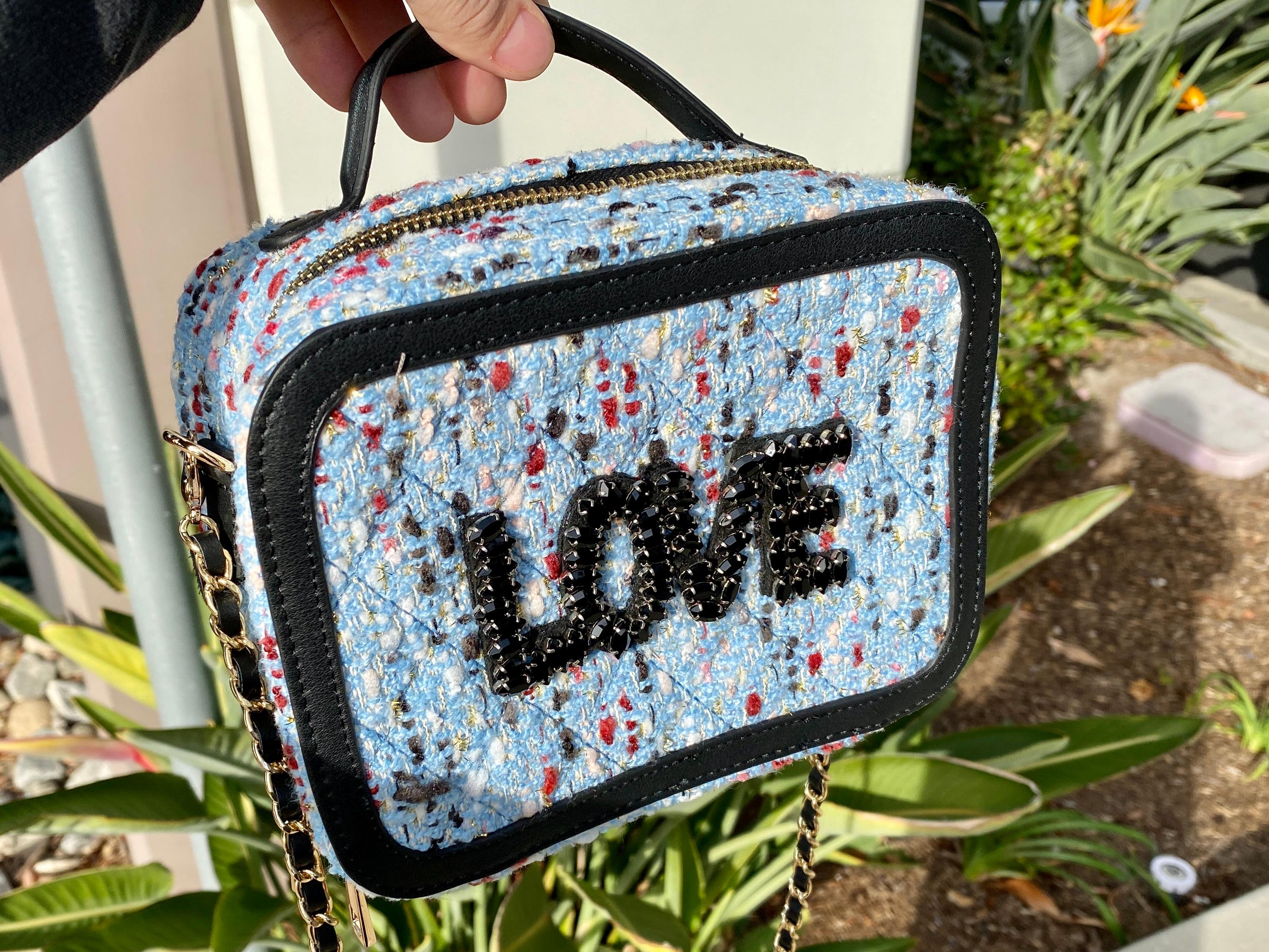 DESCRIPTION
Beaded letters on exterior 
Dual zipper closure
Single top handle
Removable woven faux leather chain strap
Double compartment interior
Interior zippered pocket

Measurements:
Length: 8in / 20.32cm
Width: 4in / 10.16cm
Height: 6in /