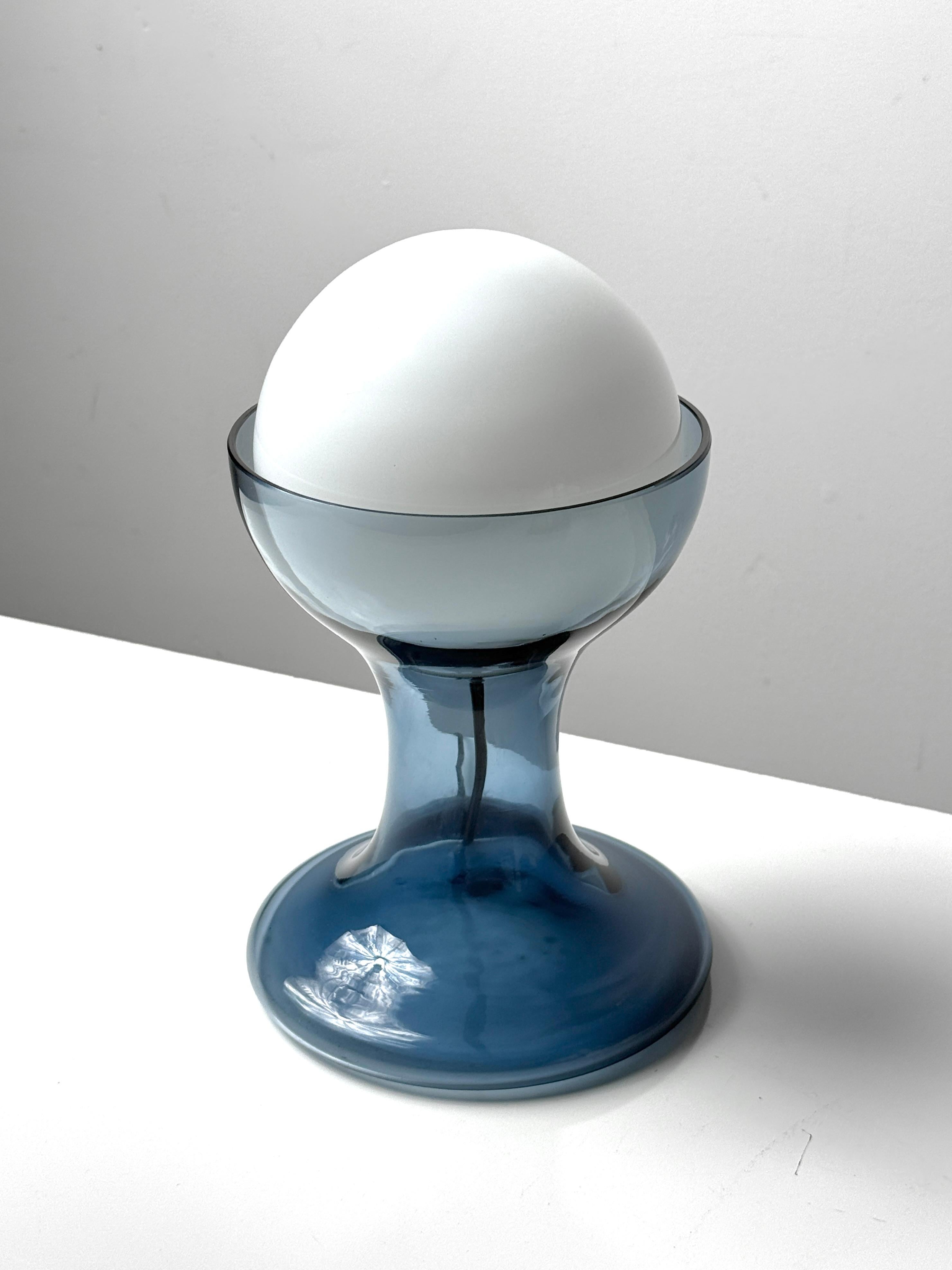 Model LT 215 table lamp in blue designed by Carlo Nason for AV Mazzega
Italy circa 1960s

Hand blown translucent blue hourglass base with inset Opaline white globe shade 
All original example in very good condition

6.5 inch diameter
10.25 inch