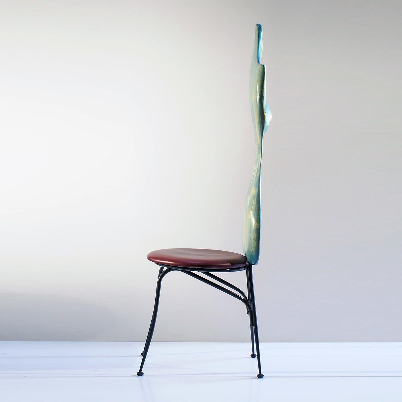 The chair is part of a limited series of unique and vibrant pieces of furniture crafted from the wood of tree trunks damaged or derived from industrial waste processing. Finished in light blue whitewash paint, the sinuous back in recovered maple