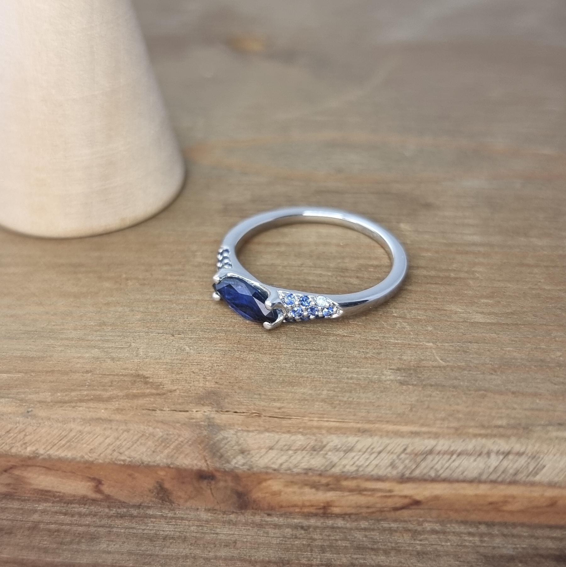 Blue Marquise Sapphire and Blue Round Sapphires in a White Gold Ring For Sale 1