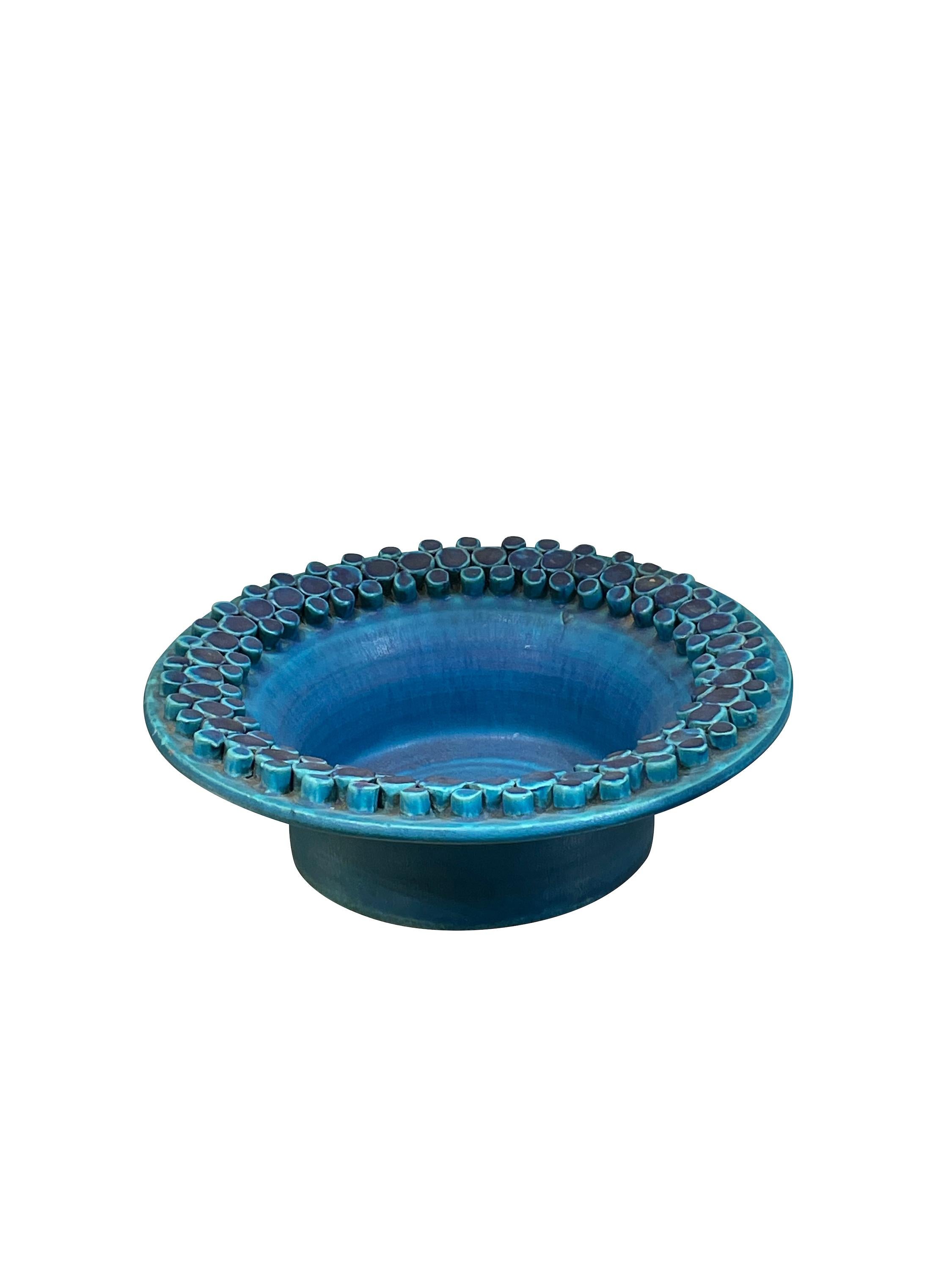 Mid Century French matte blue glazed footed bowl with
raised decorative pattern border.
