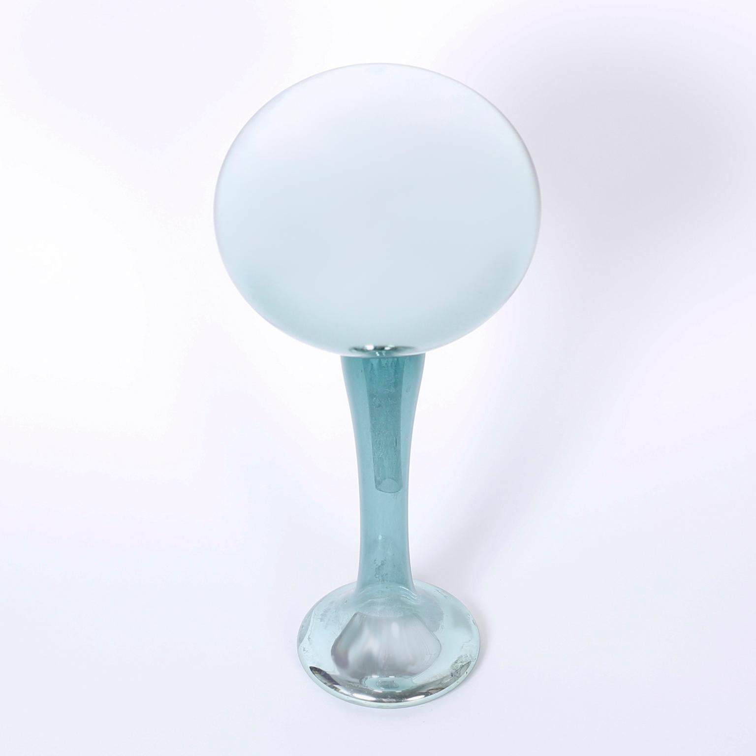 two-piece mercury glass gazing ball or sculpture with an alluring ice blue color and modern graceful form.