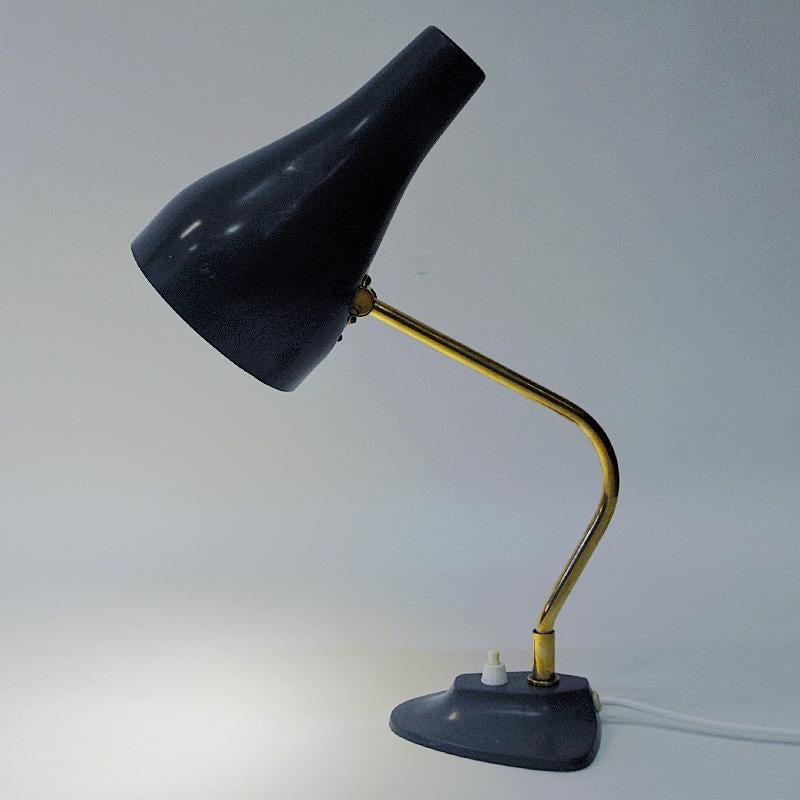 Lovely dark blue metal tablelamp mod 1267 produced by ASEA Belysning, Sweden in the 1950s. Brass stem which are adjustable in all directions. Nice greyblue painted shade and base. Lightswith located at the base. Marked with the model number 1267 and