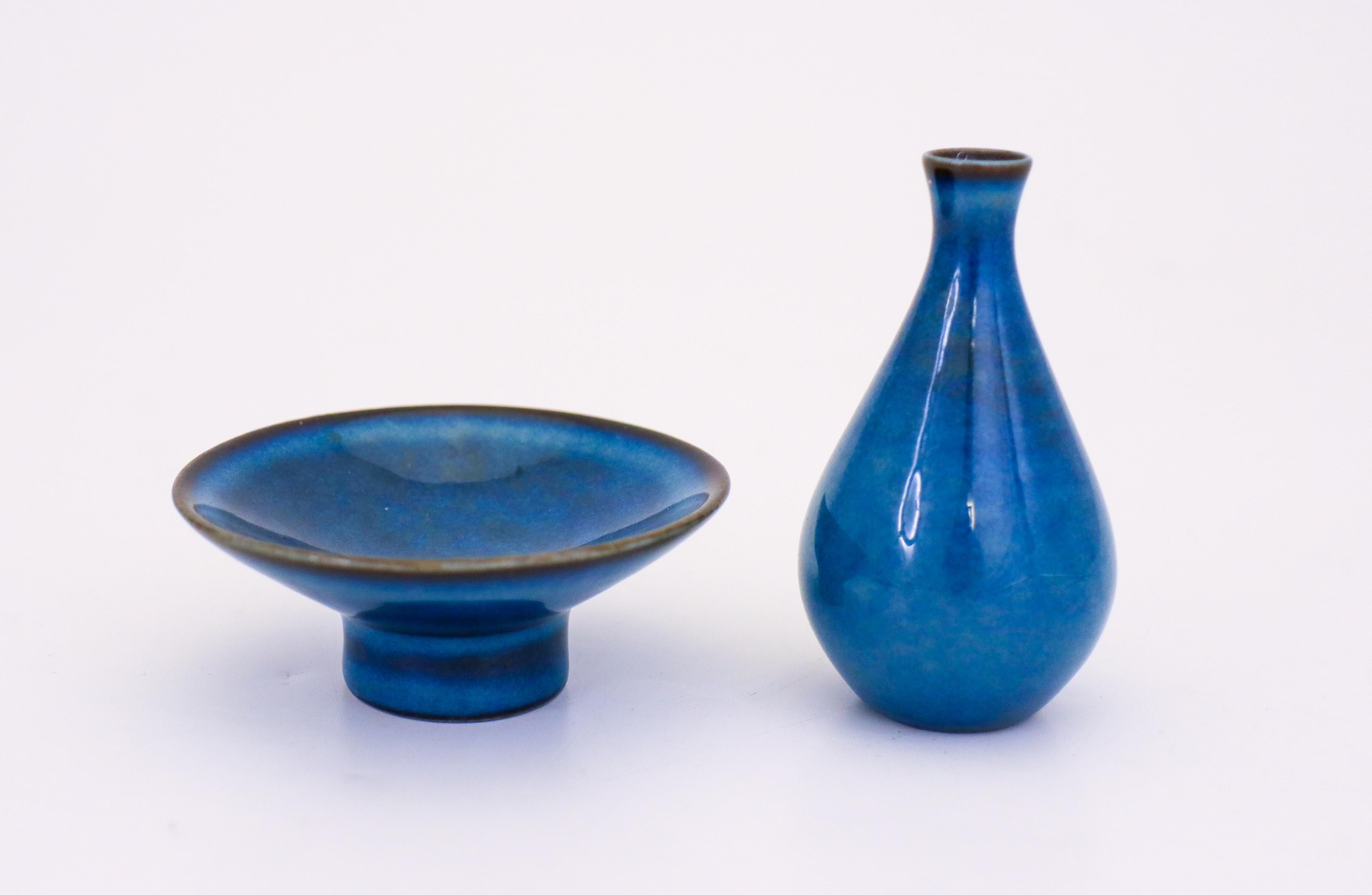 A bowl and a vase with shiny blue glaze designed by Bertil Lundgren at Rörstrand. They are between 3 - 7 cm (1.2