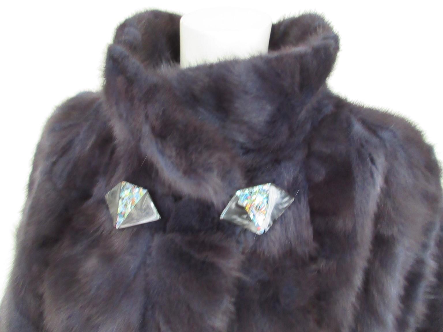 This coat is made of dyed blue soft mink fur

We offer more exclusive fur items, view our frontstore

Details:
It has 2 pockets and 4 closing hooks 
2 Art deco buttons at collar
inside pocket
fully lined
Its in pristine condition
size fits as