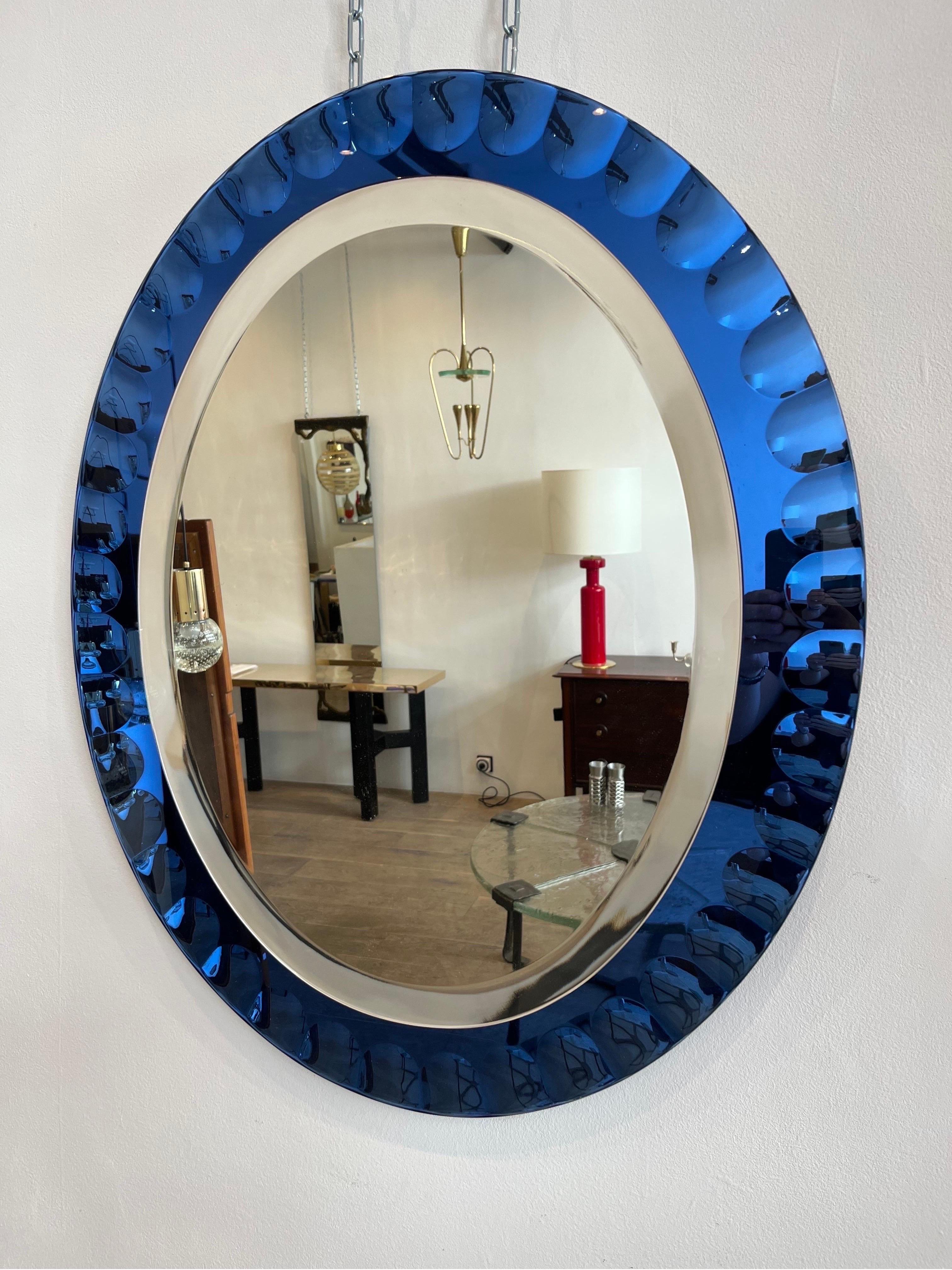 Cristal Arte is an important glass manufacturer from Torino. The present mirror dates circa 1960s. The external side is blue and worked in order to create to some interesting reflection of the light.
