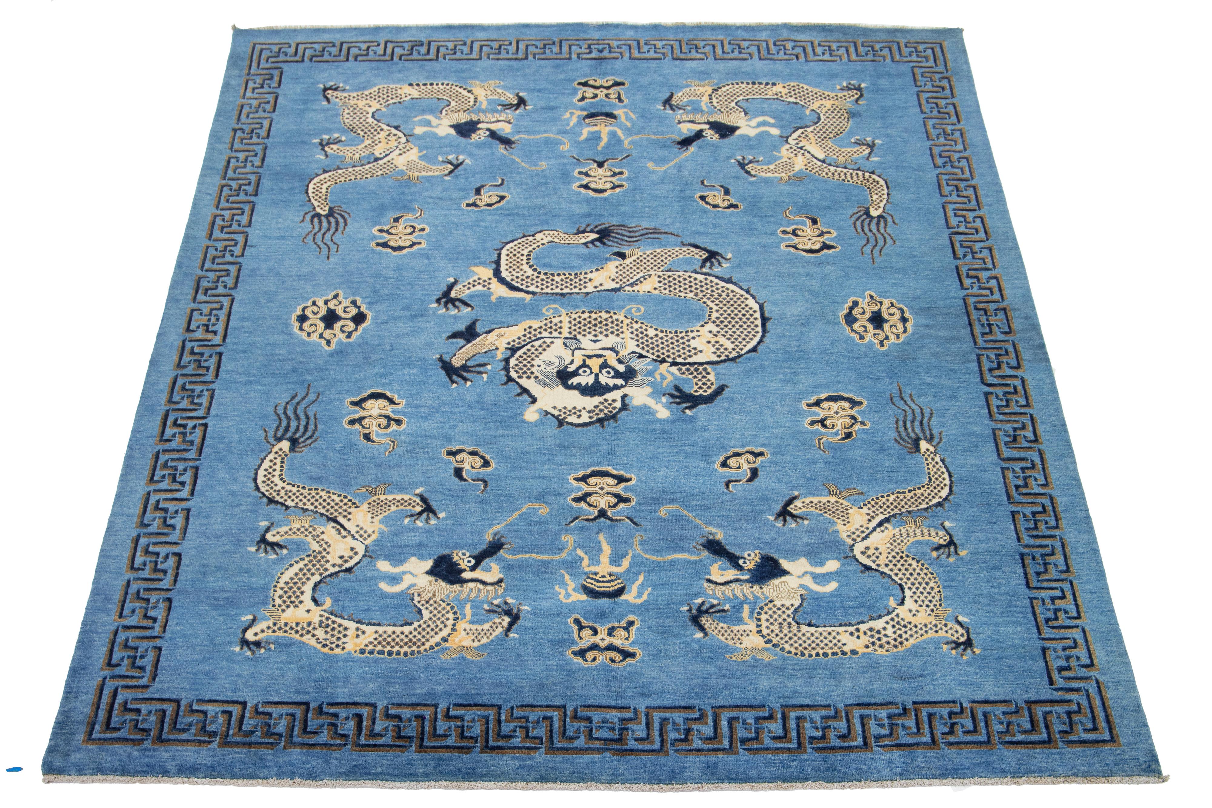 A beautiful modern Chinese-style hand-knotted wool rug with a navy blue field and beige accents throughout the traditional Chinese dragon design. 

This rug measures 8' x 9'9