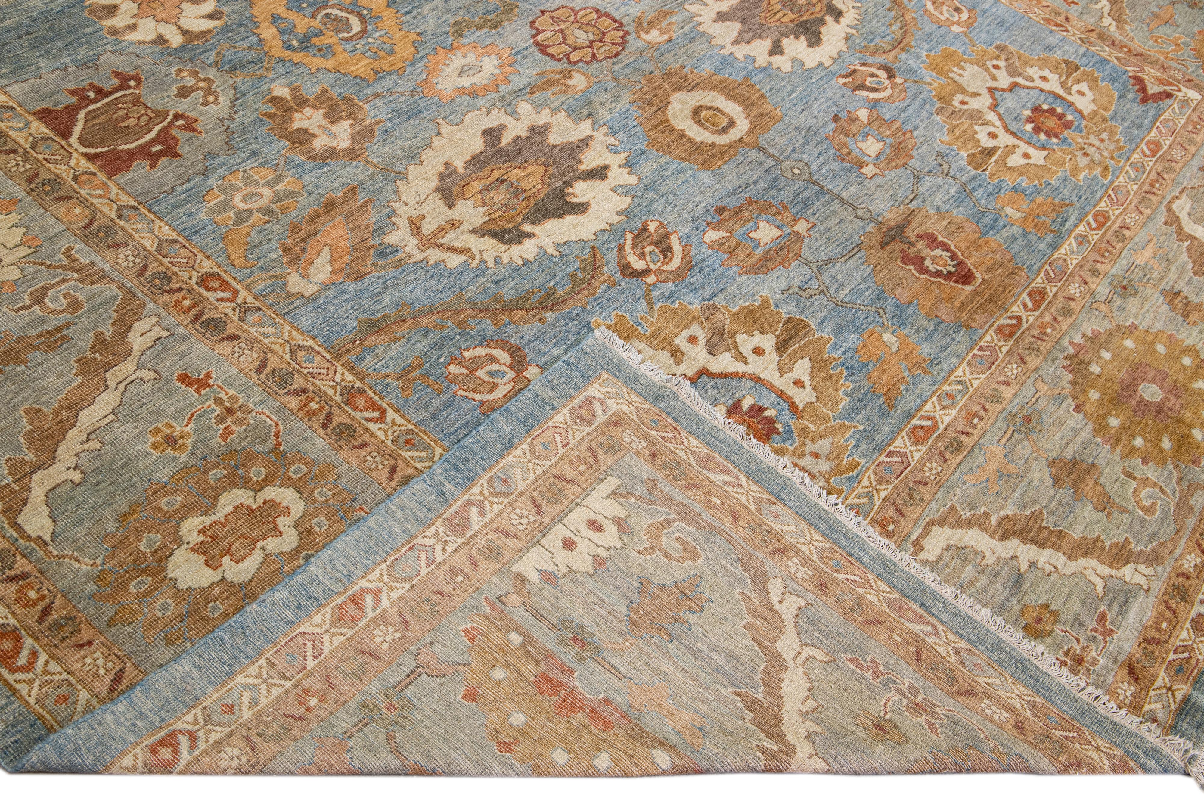 Beautiful modern Sultanabad hand-knotted wool rug with a blue field. This Sultanabad rug has brown, terracotta, and peach accents in a gorgeous all-over classic floral pattern design.

This rug measures: 12'9