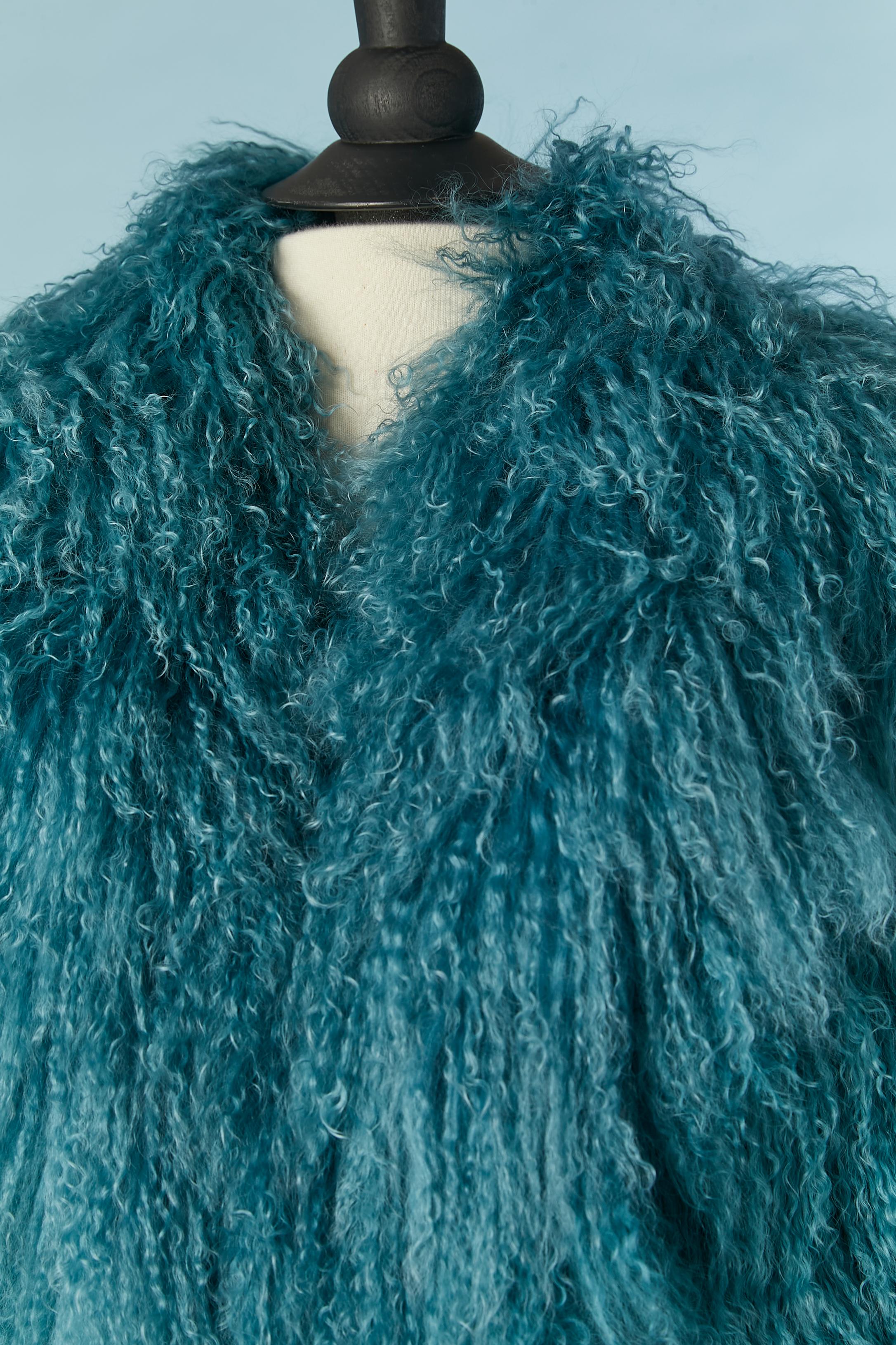 Blue Mongolian's fur single breasted coat. Hook & eye closure in the middle front. Black  jacquard lining ( no fabric composition tag but probably rayon) 
SIZE XXL on tag but fit more likely L 