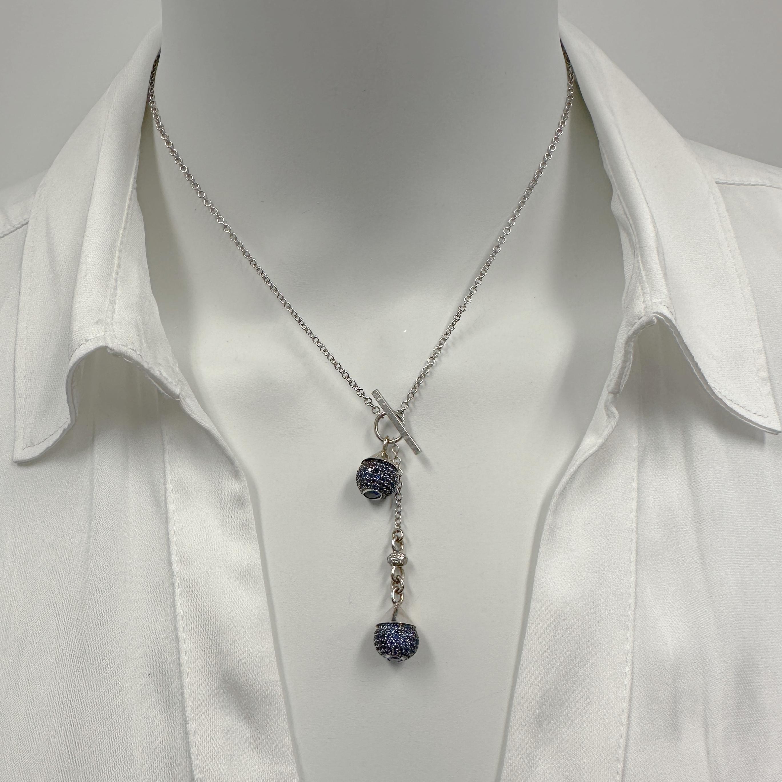 Eytan Brandes tore apart a dressy sapphire cuff link (see final photo in array) to make this incredible, one-of-a-kind* toggle necklace.  

The sapphire balls are an incredible feat of stone-setting; it's not easy to pave-set stones on a sphere! 