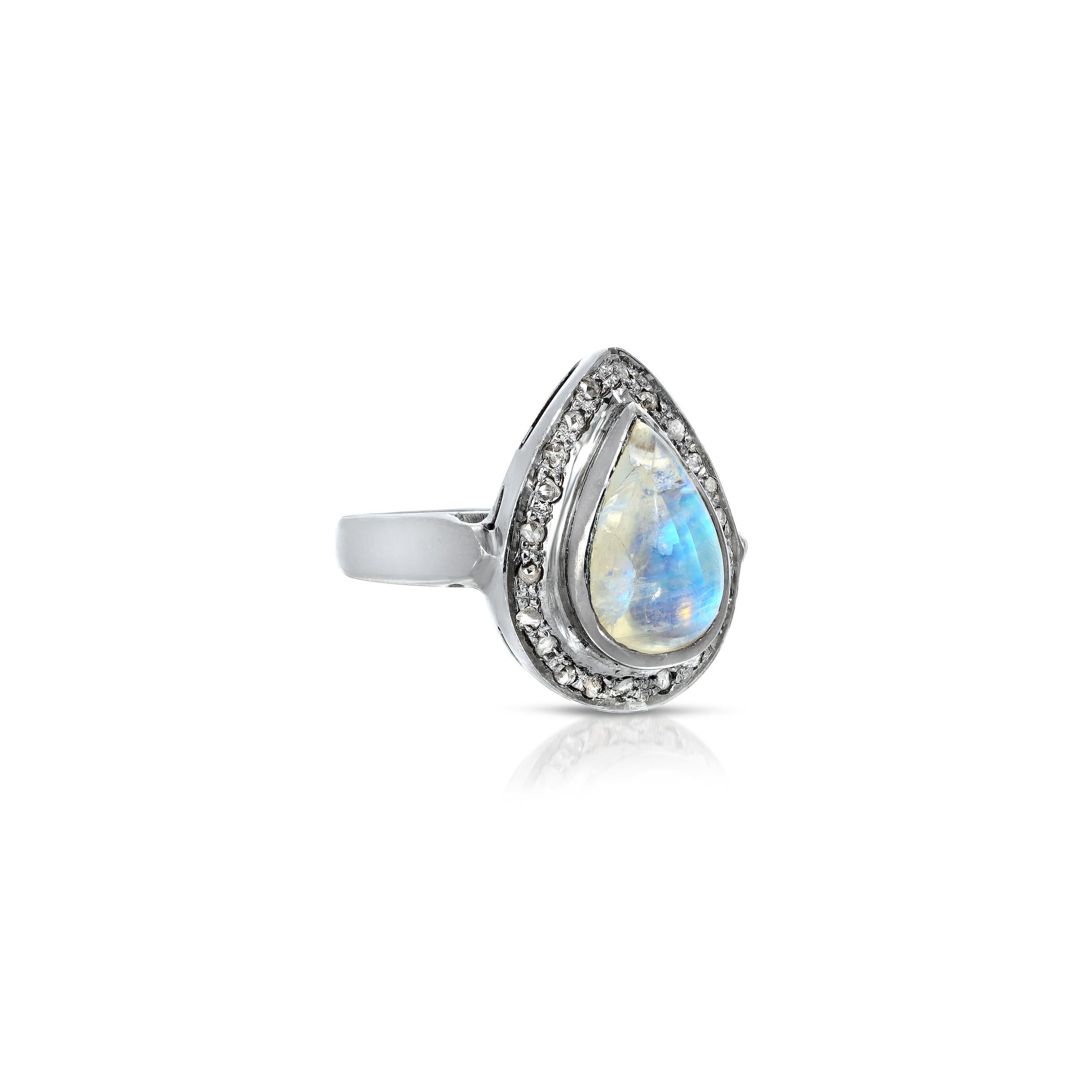 A 2.80 Karats pear shaped Moonstone with shimmering iridescent icy blue hues and beautiful ribbons in the gem stone set with .30 Carats of White Diamonds in nouveau Victorian style statement ring of Blackened Oxidized Silver.
