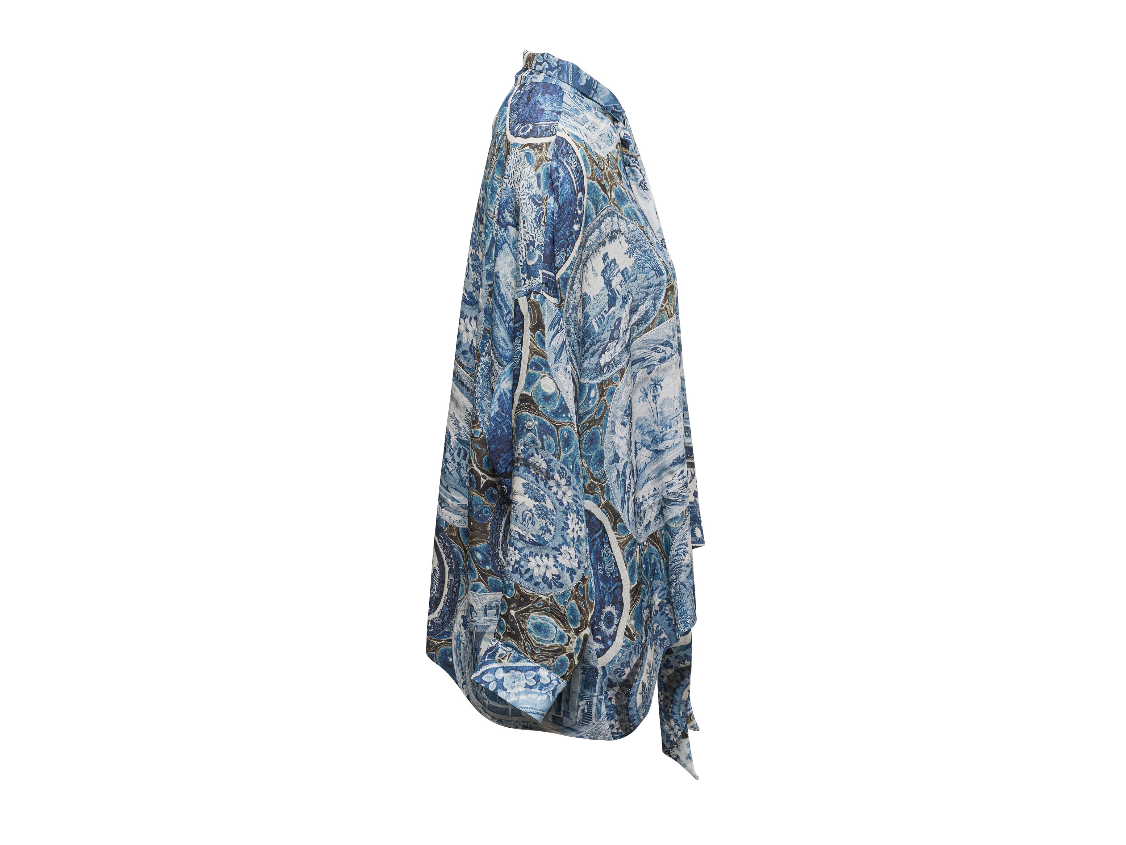 Blue and multicolor printed silk blouse by Libertine. Pussy bow detailing at front neckline. Long sleeves. 54