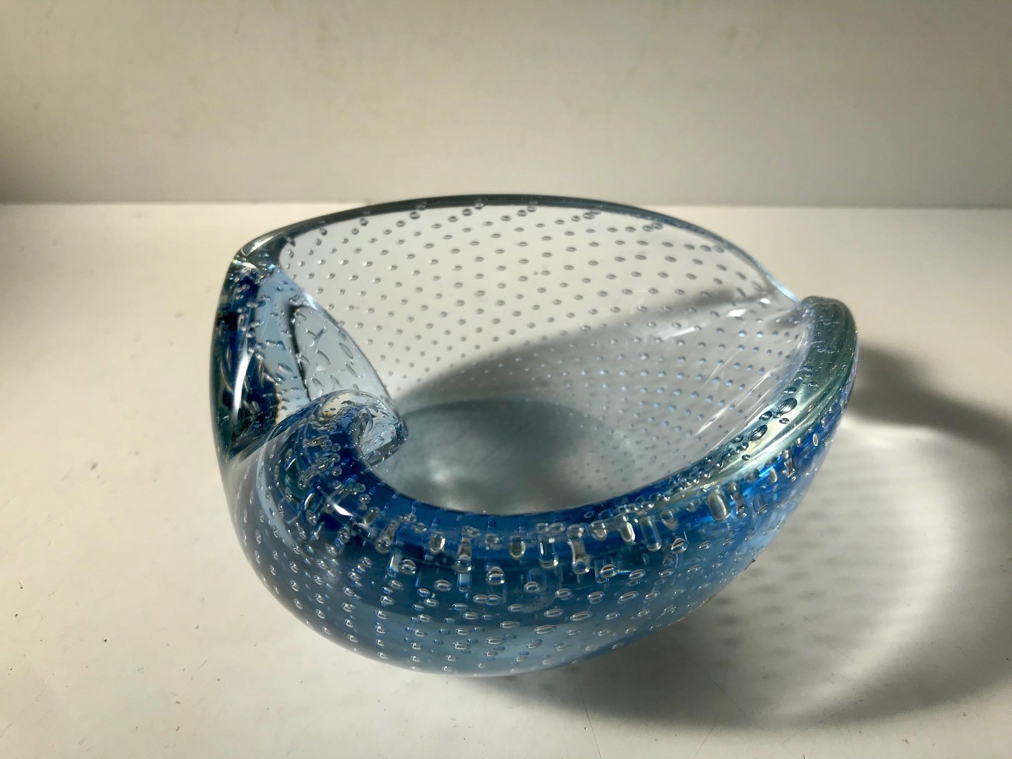 Hand blown aqua blue collapsed Murano art glass bowl or ashtray. Executed with incapsulated and controlled air bubbles. It is attributed to Archimede Seguso, Italy, circa 1940s-1950s.