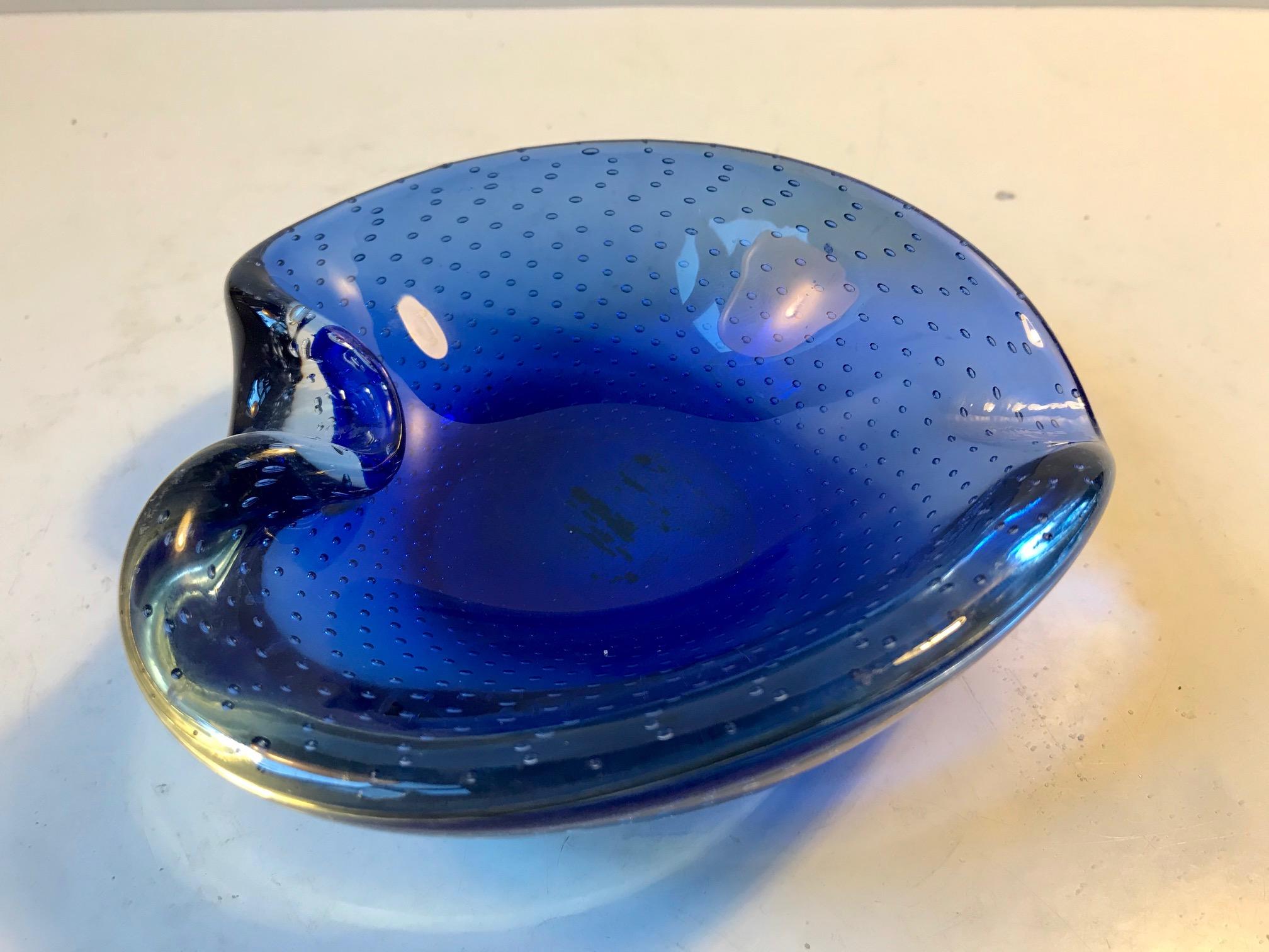 Hand blown cobalt blue collapsed Murano art glass bowl or ashtray. Executed with incapsulated and controlled air bubbles. It is attributed to Archimede Seguso, Italy, circa 1940s-1950s.