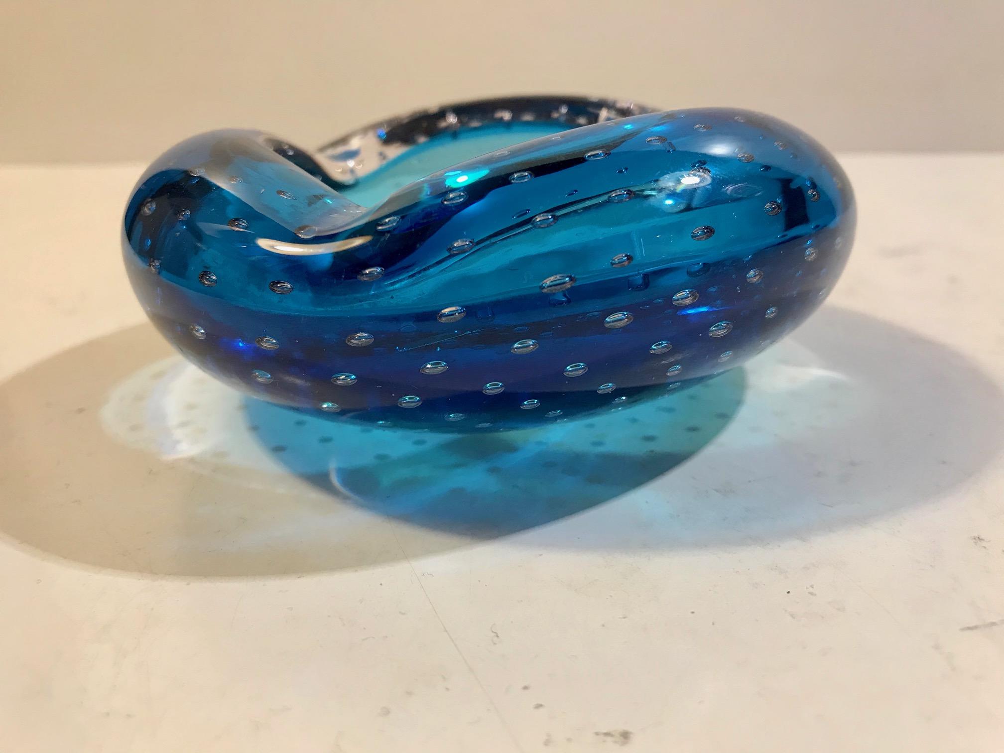 Hand blown cobalt blue collapsed Murano art glass bowl or ashtray. Executed with incapsulated and controlled air bubbles. It is attributed to Archimede Seguso, Italy, circa 1940s-1950s.