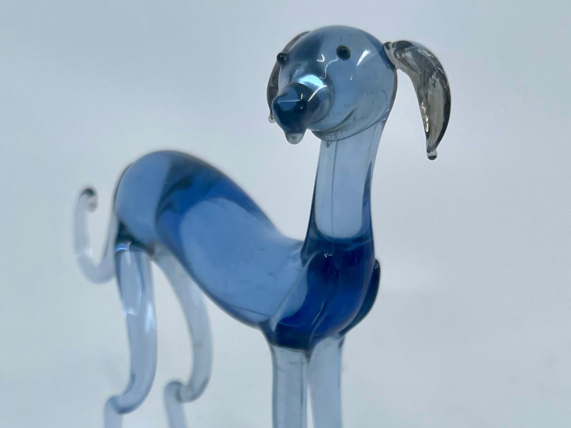 Blue Murano dogs. Vintage set of fine blown Murano blue glass dogs father mother and puppy, grey hound/ whippet. Italy, 1940’s 
Dimensions:
Largest 4