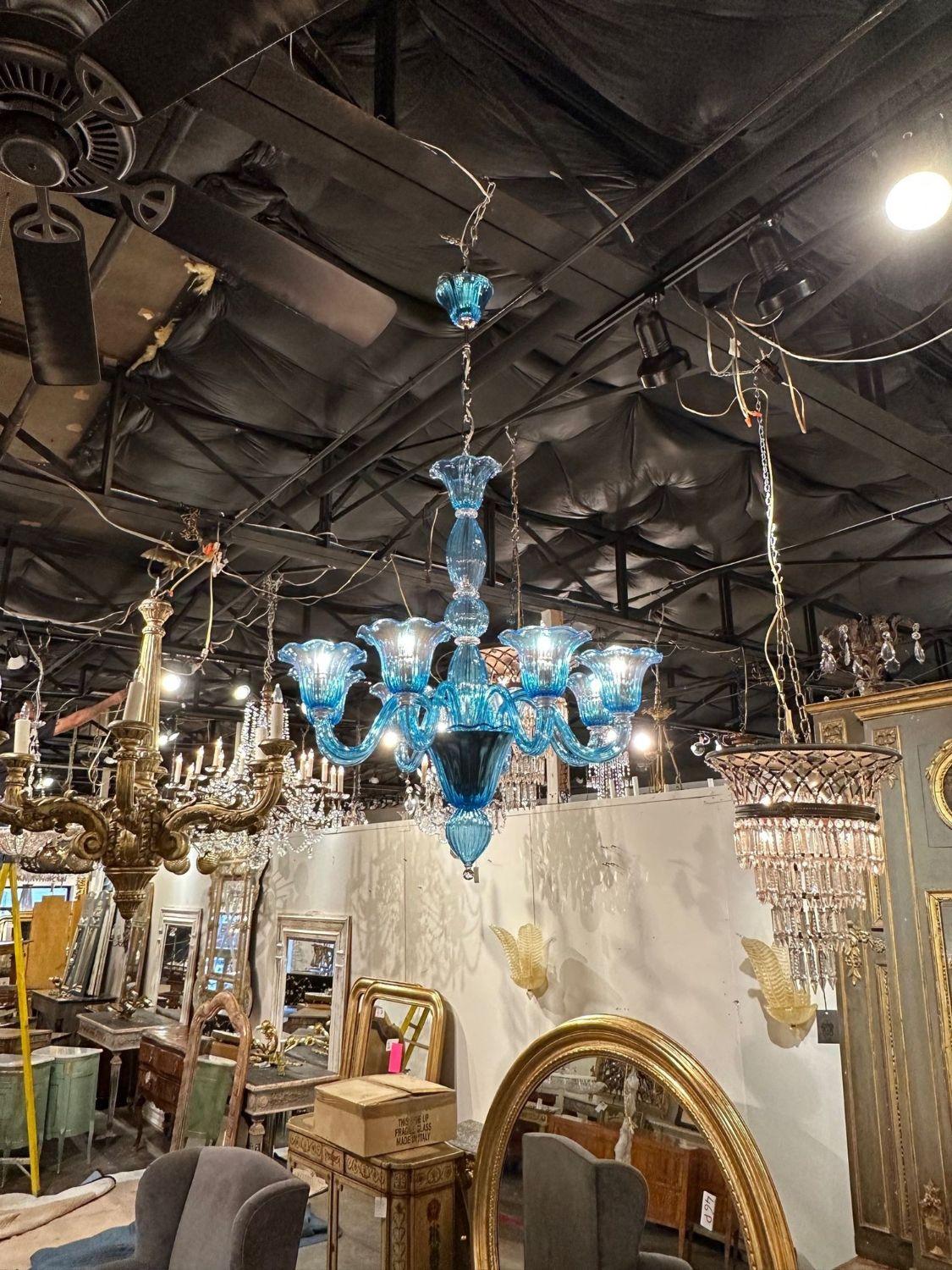 Decorative blue chandelier with brilliant blue Murano glass. A very unique fixture that is sure to impress!