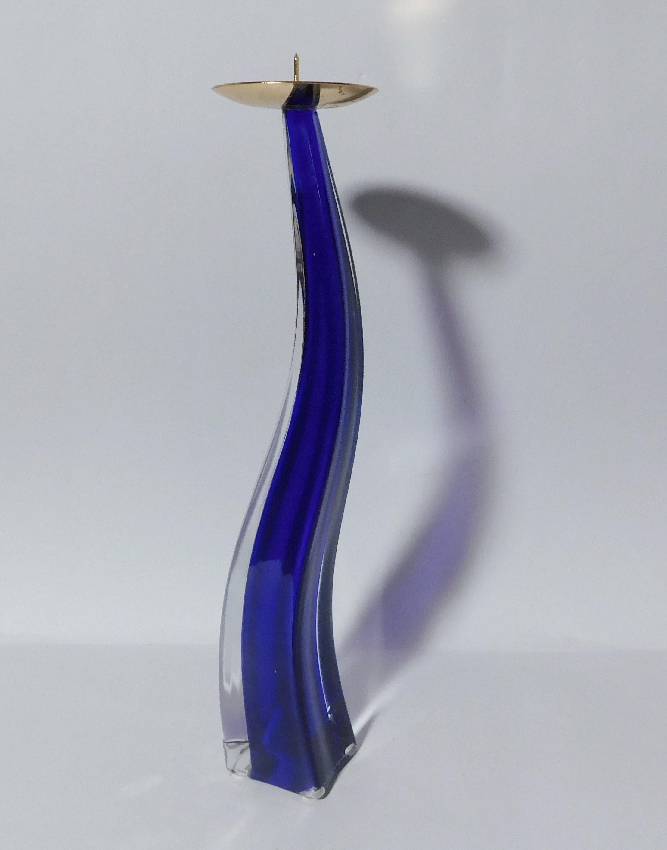 Italian curved Murano candlestick hand blown in cobalt blue and clear glass, made in Italy by Maurizio Toso, circa 1980s 
Original maker's mark on the base
Measures: height 13 inches, diameter 2.5 inches
1 available in stock in Italy
This piece