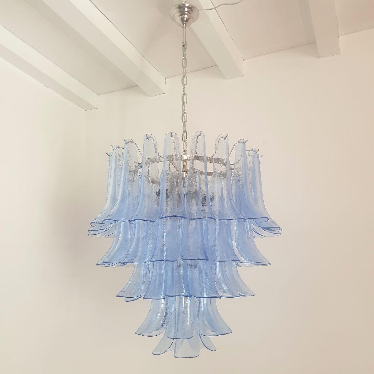Mid century modern five-tier transparent blue Murano glass chandelier, by Mazzega, Italy, 1980s.
A pair available - Set of two chandeliers. Sold and priced individually.
To inquire about the pair, select 2 items.
The light blue Murano glass