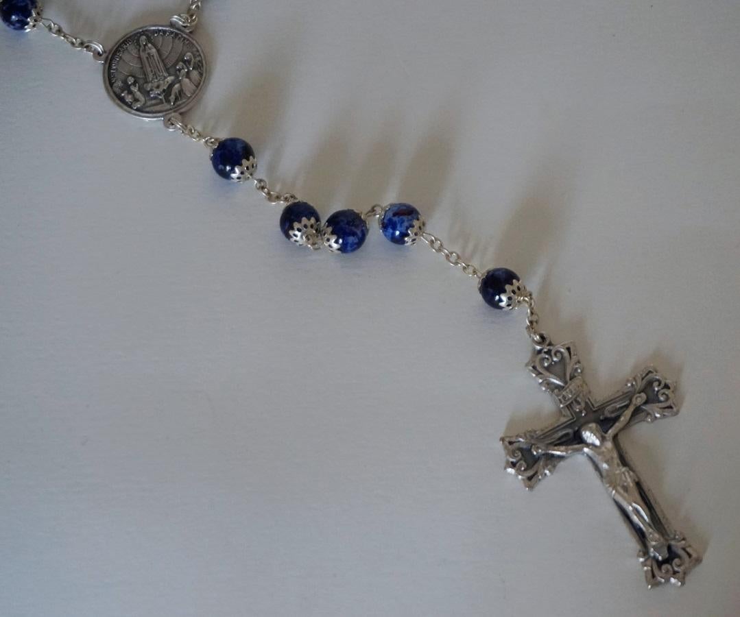 This is a rosary of the pilgrim's souvenir collection of the Centenary Lady of Fátima Apparitions and on the occasion of the visit of Pope Francis to the Sanctuary of Fátima, Portugal, 2017.
It was manufactured in Portugal and made of cobalt blue