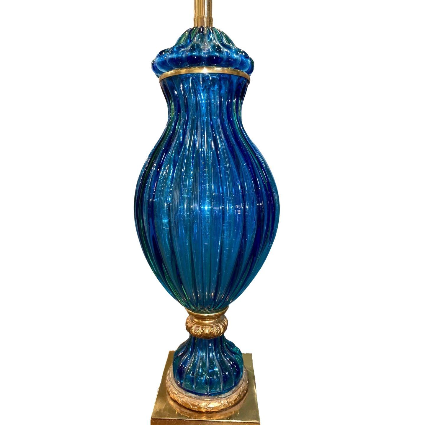 Beautiful blue Murano lamp with a gold base.