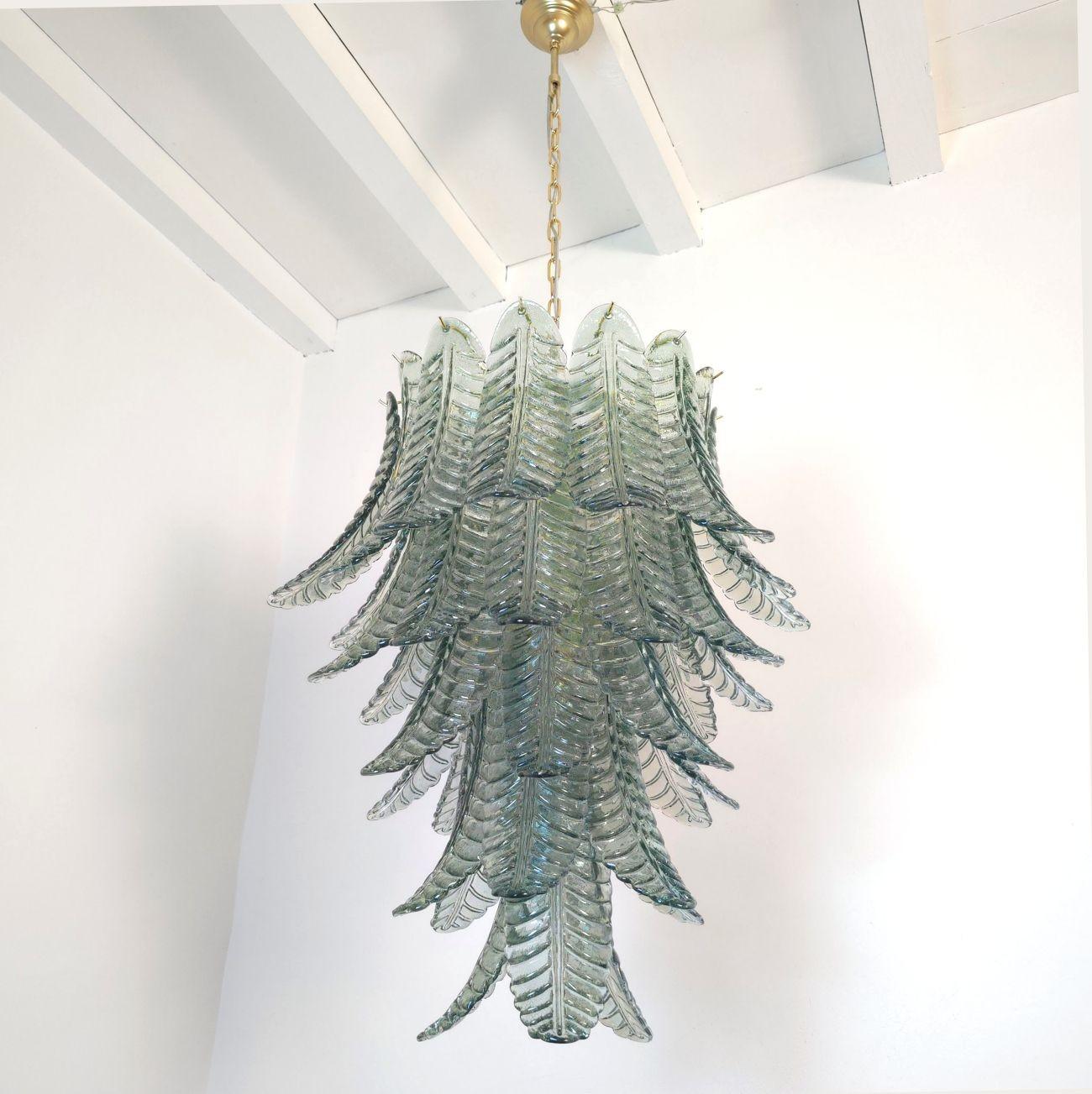 Grand lustre en verre de Murano du milieu du siècle dernier, attribué à Mazzega, Italie, années 1980.
Le lustre du milieu du siècle est composé de feuilles en verre Murano bleu et d'un cadre plaqué or.
Les feuilles en verre de Murano sont