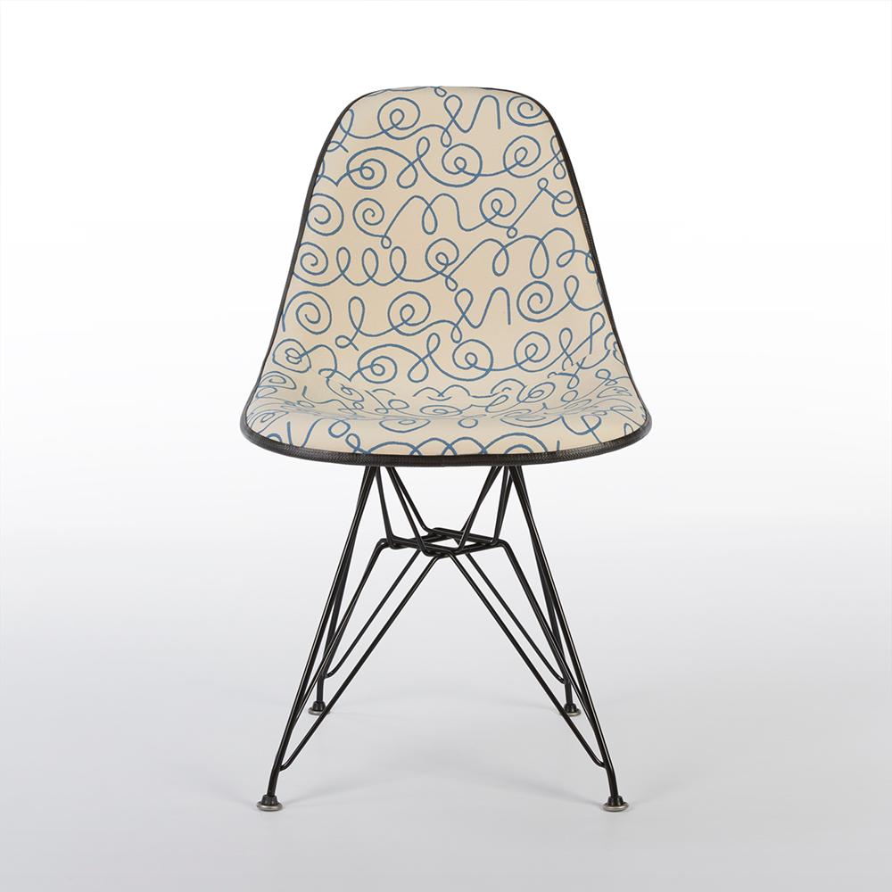 A beautifully reconditioned Eames Herman Miller original DSR side shell chair has been re-adorned in original Alexander Girard fabric called 'Blue Names'. Coupled with the used, newer, DSR base, this makes a great example of the classic side chair.