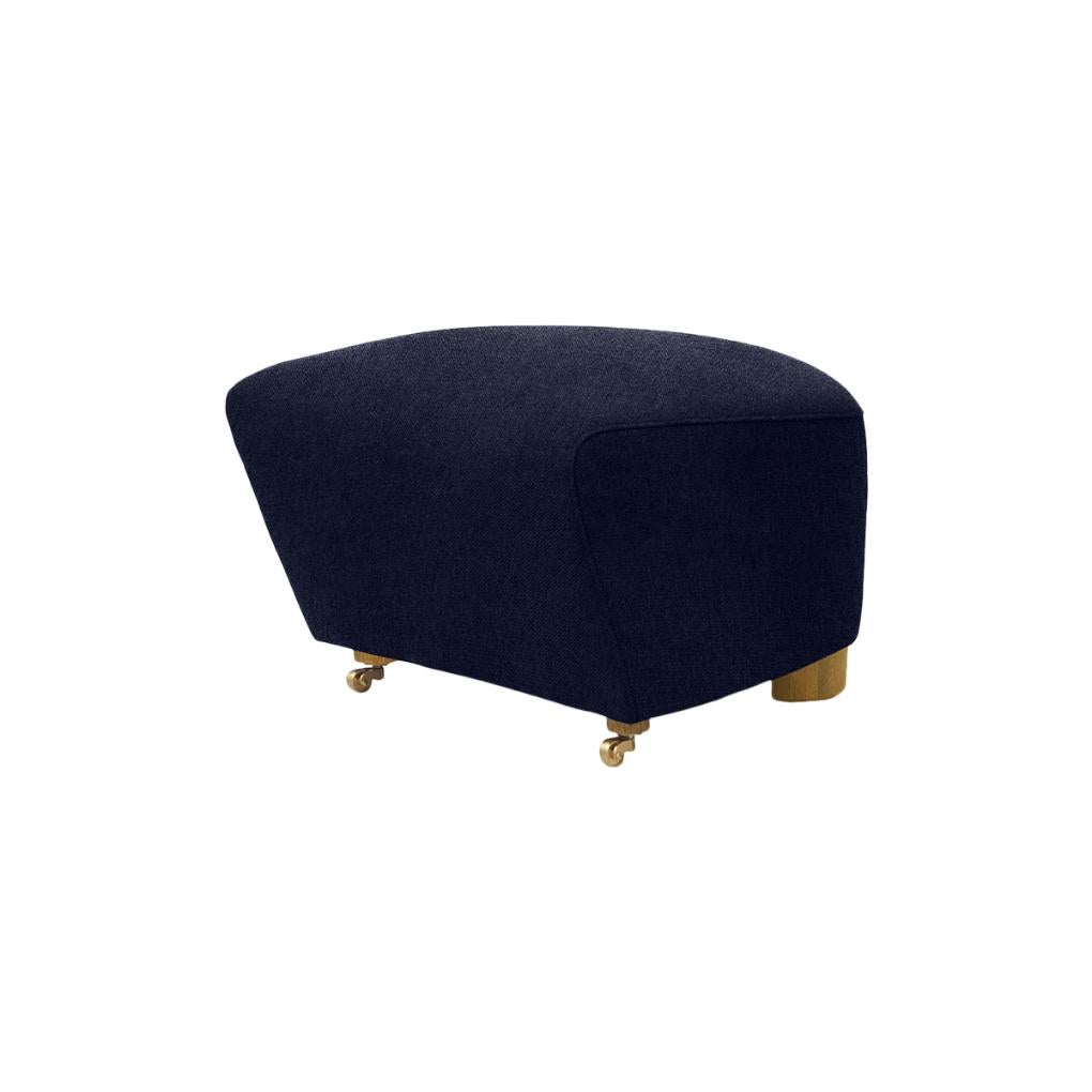 Blue natural oak hallingdal the tired man footstool by Lassen.
Dimensions: W 55 x D 53 x H 36 cm. 
Materials: Textile.

Flemming Lassen designed the overstuffed easy chair, The Tired Man, for The Copenhagen Cabinetmakers’ Guild Competition in