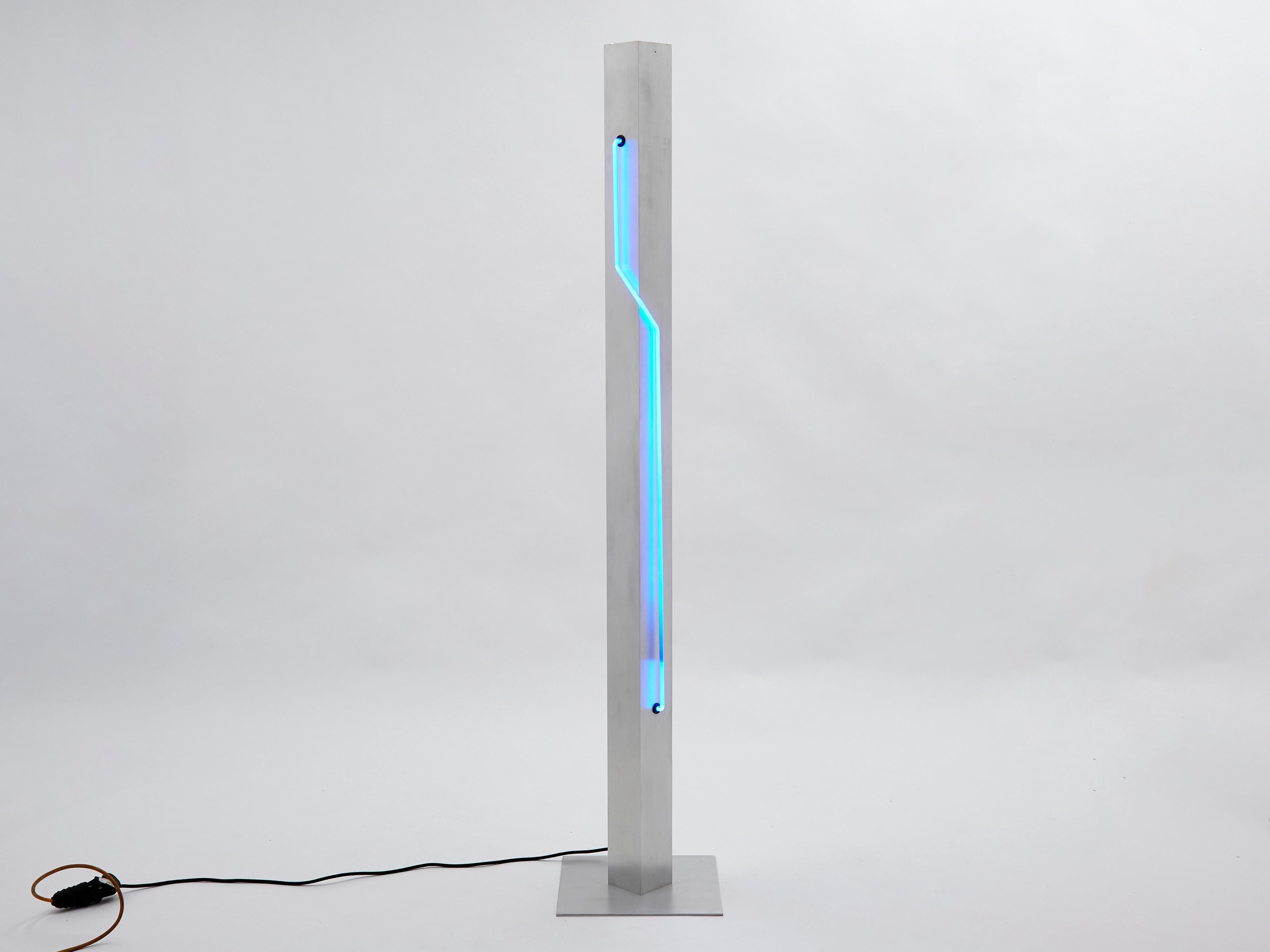Post-Modern totem blue neon light designed by Rudi Stern and Dan Chelsea for the New-York gallery Let There Be Neon in 1983, with lighting elements provided by George Kovacs. The central column in brushed stainless steel is four inches wide and