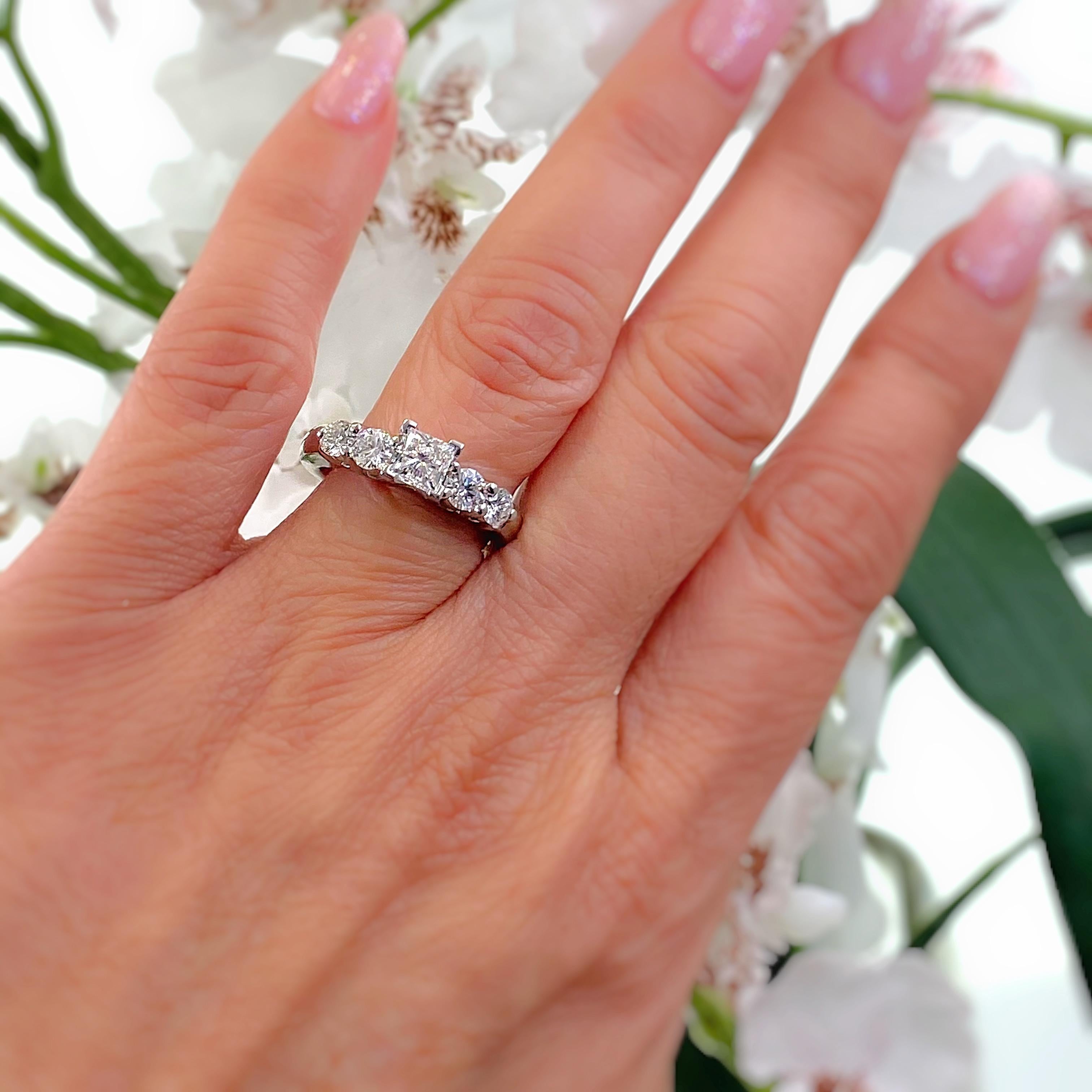 Blue Nile Diamond Engagement Ring
Style:  Solitaire with Accents
AGS Diamond Grading Report:  #7438305
Metal:  Platinum
Size:  6.5 - sizable
TCW:  1.36 tcw
Main Diamond:  Princess Diamond 0.70 cts
Color & Clarity:  G - VS1
Accent Diamonds:  4 Round