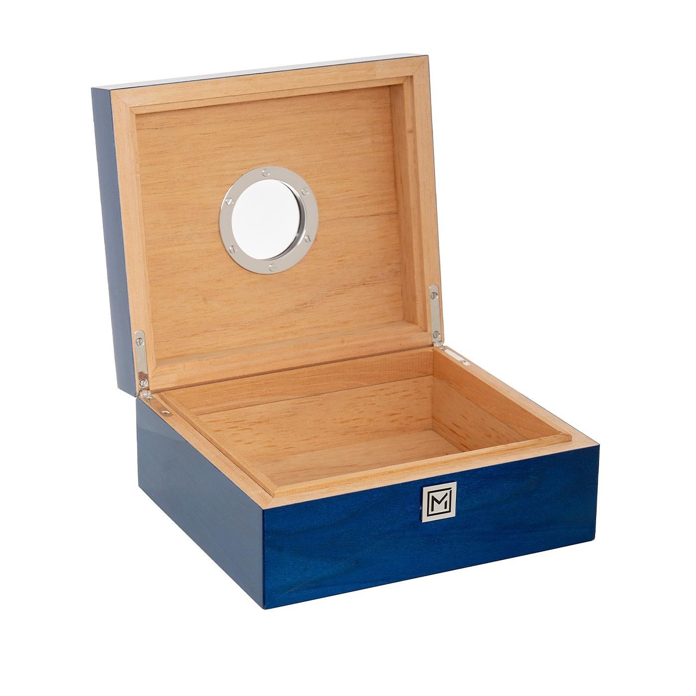 From the Yacht collection, Blue Ocean is the smallest humidor of Maccarrone's collections. Metal accessories are in chromed brass and high gloss mahogany and maple inlay embellish this object. Elegant and refined, our humidor is designed for all