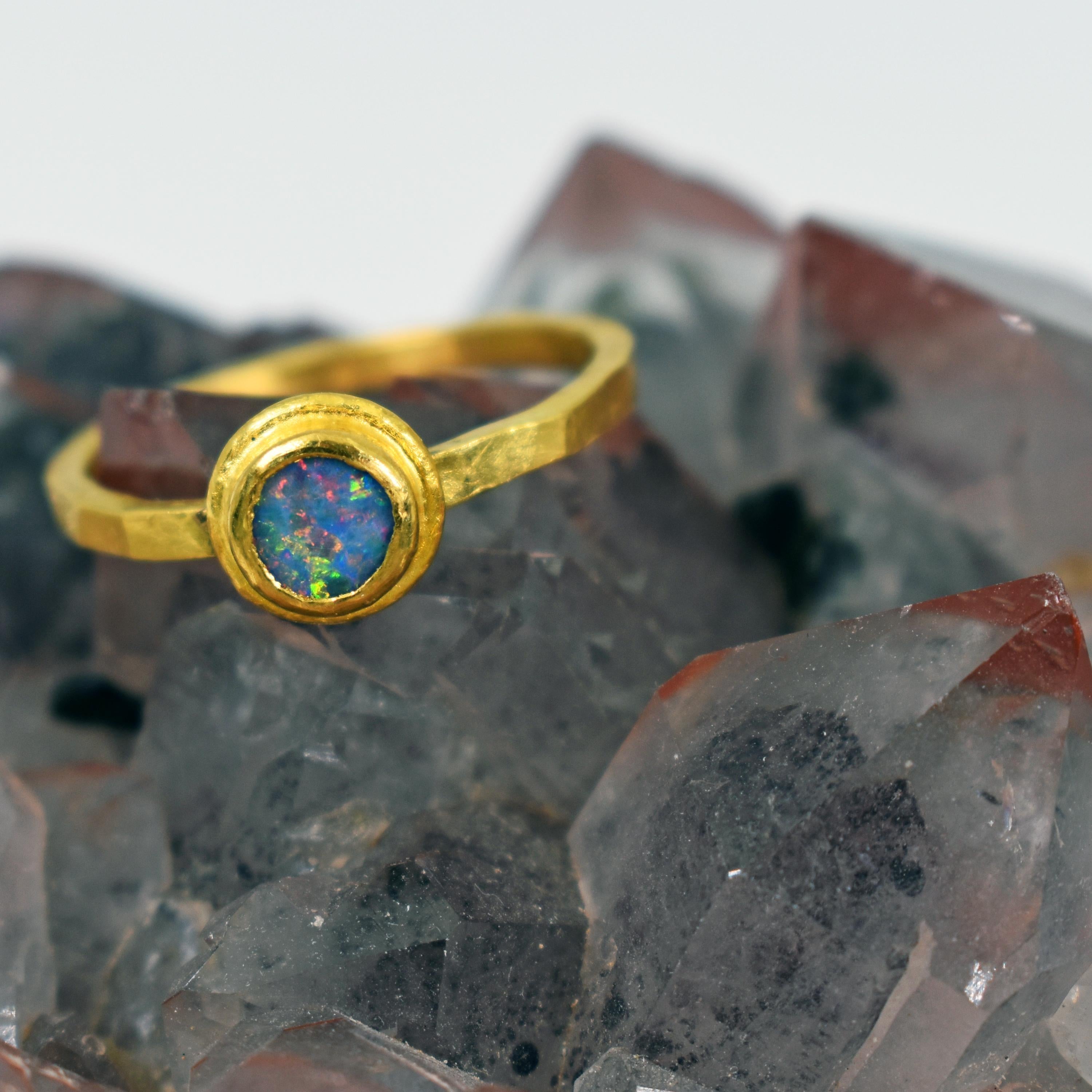 Blue Opal and 22k yellow gold bezel stackable artisan ring. Ring is size 6.5 and is finished with a hammered, satin finish. Contemporary, yet rustic and delicate, minimal ring with a gorgeous, colorful Opal gemstone. 