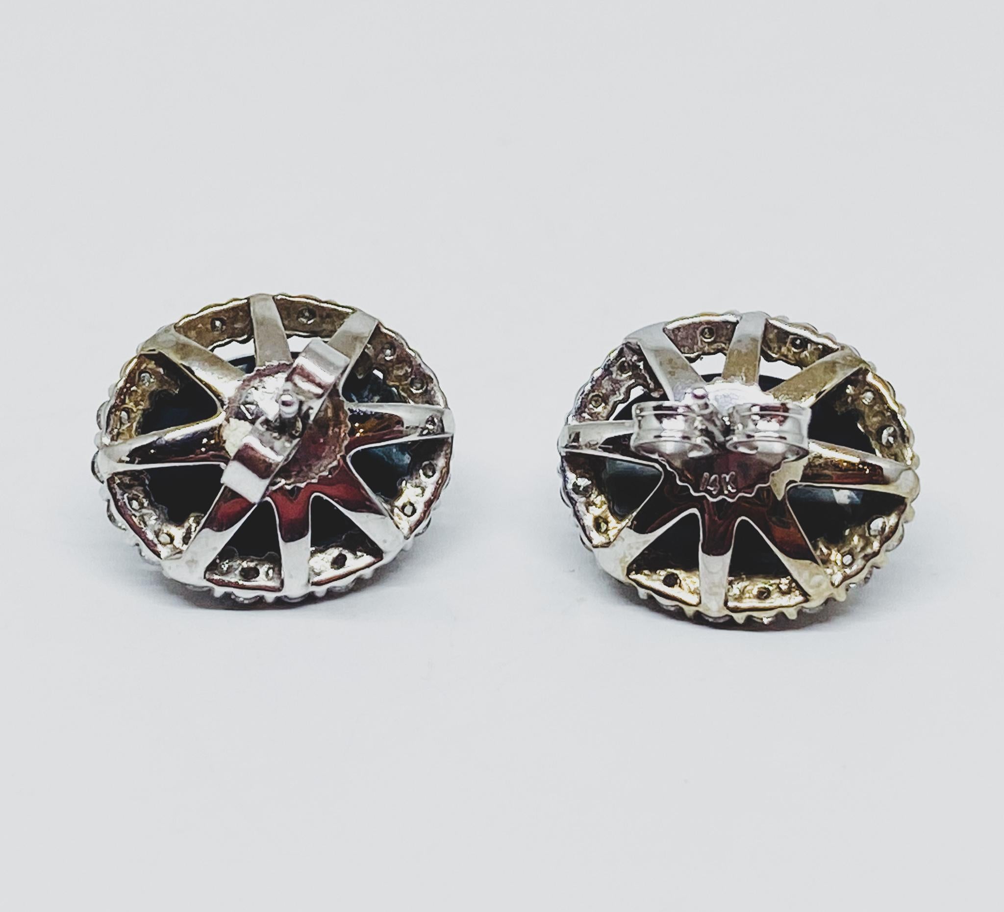 Classic stud earrings in 14KT white gold featuring beautiful opals weighing 1.00 carat in a pale blue-green Caribbean Sea color.  This stone features an assortment of colored inclusions to give it a unique, celestial look. Each opal is surrounded by