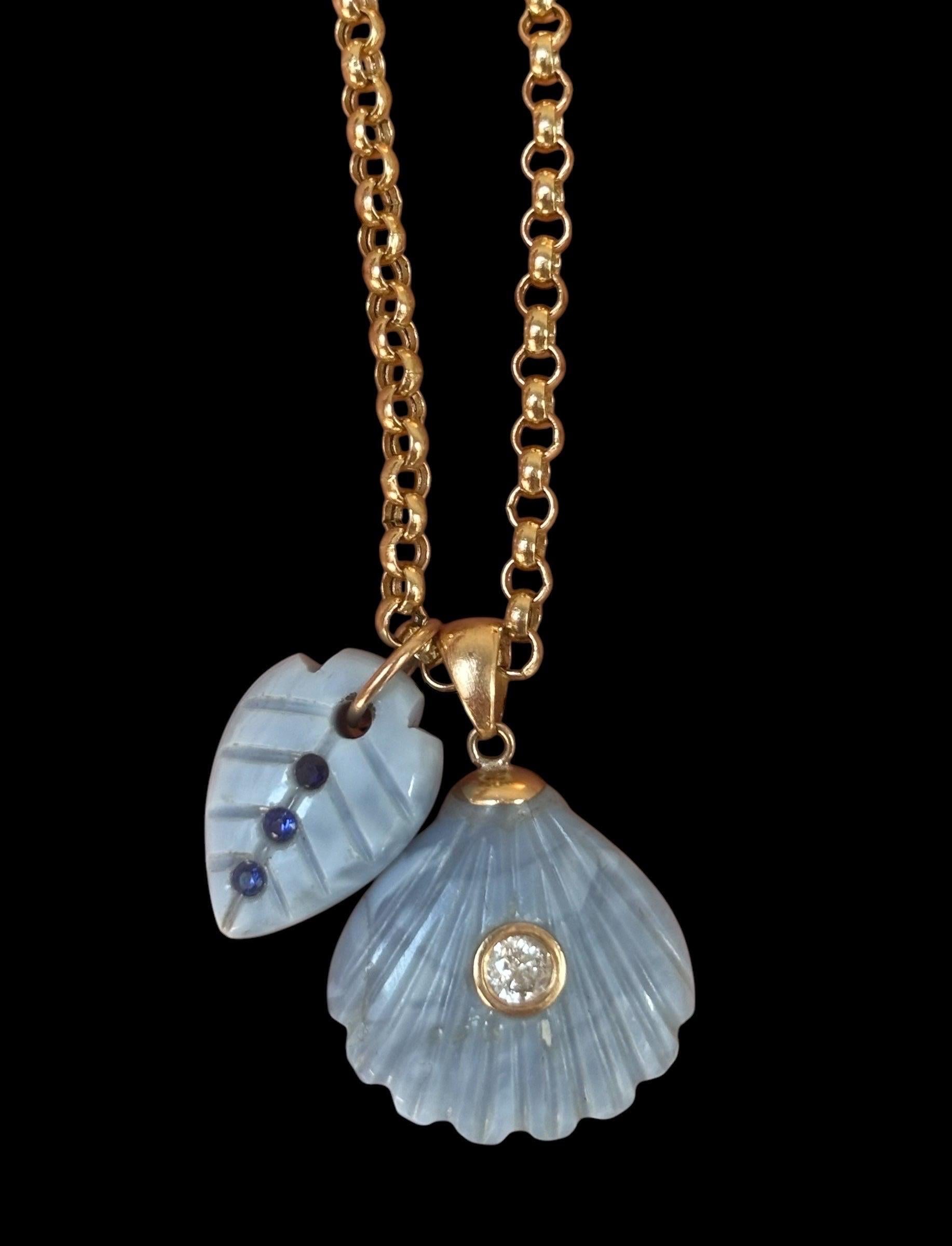Blue Opal Necklace

Blue Opal, Diamond, Blue Sapphires & 14k Gold
This is a one-of-a-kind necklace. The 14k gold rolo chain is fourteen inches in length. It comes with two special Blue Opal pendants.

The first pendant is a carved blue opal shell