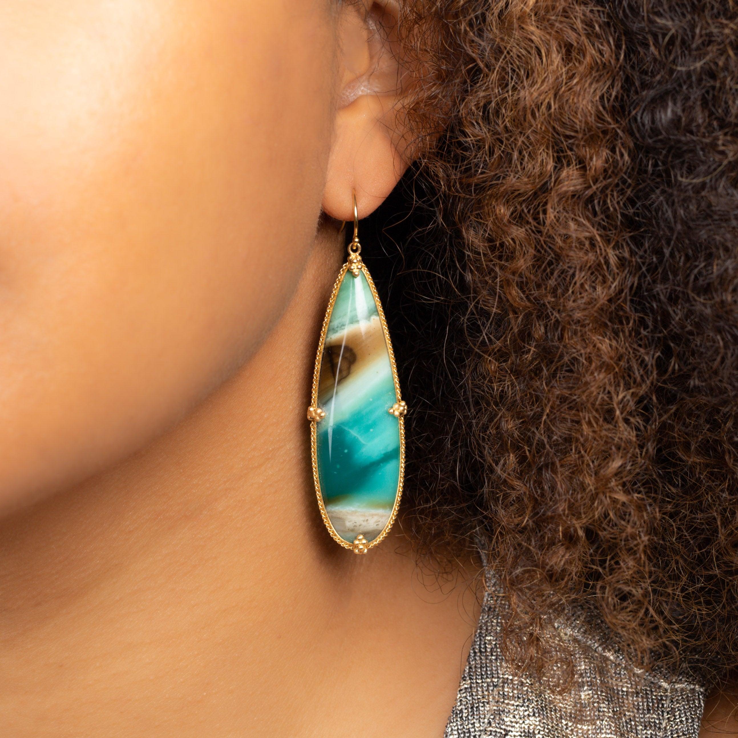 Emerging from a recently-discovered ancient petrified forest on the slopes of Mt. Tjikolak in Indonesia, this magnificent stone has only been in our awareness for the last three years. Like Caribbean waters against hot sand, these earrings are