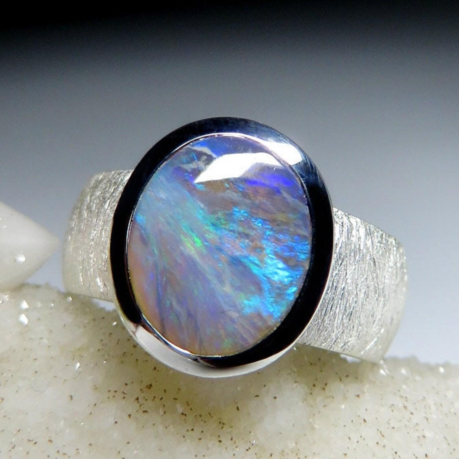Matte finish silver ring with natural Dark Opal
opal origin - Australia 
stone measurements - 0.079 х 0.31 х 0.39 in / 2 х 8 х 10 mm 
weight of the stone - 1.9 carats
tone of opal № 6
ring weight - 7.26 grams 
ring size - 6 US