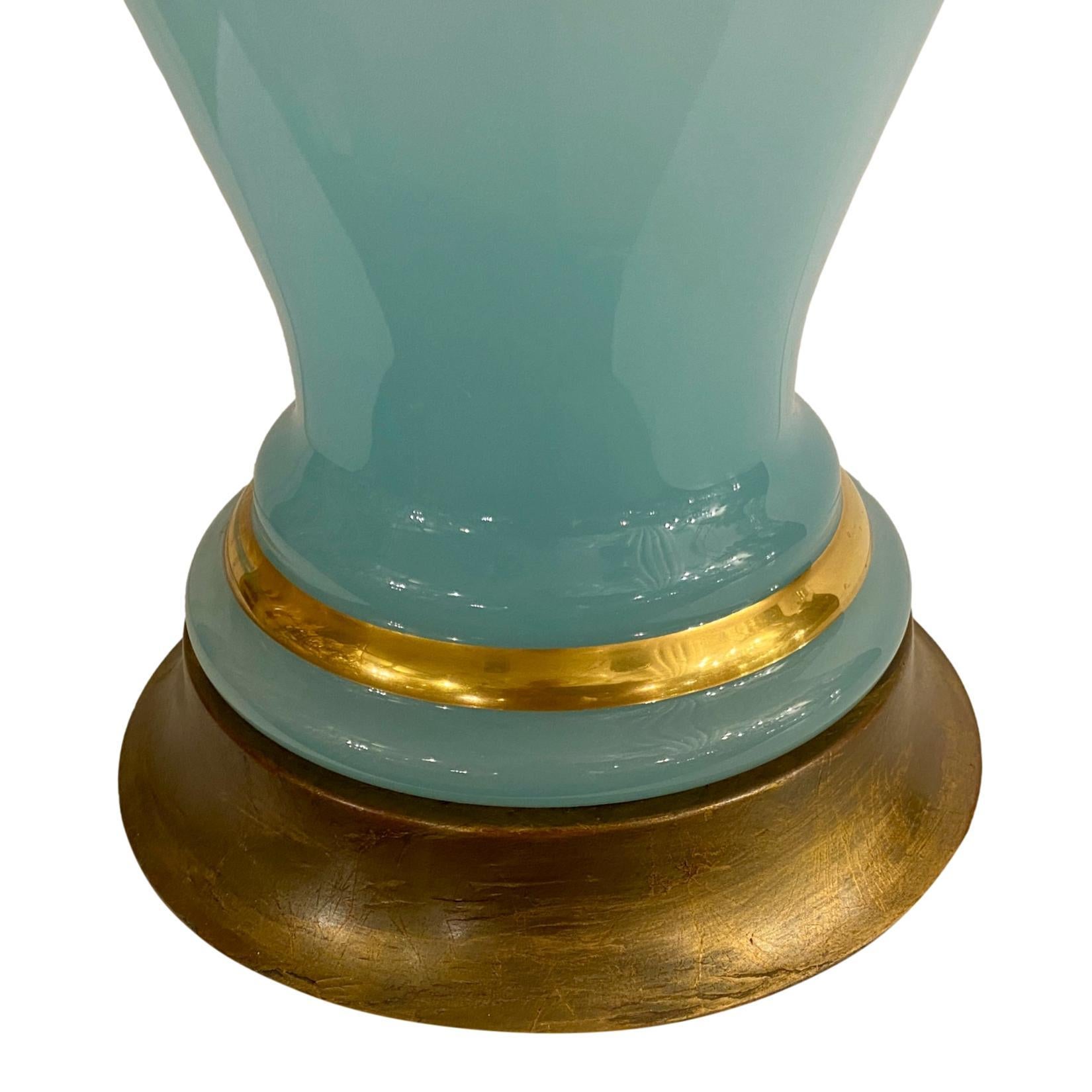 A circa 1920's French light blue opaline table lamp with gilt details on body.

Measurements:
Height of body: 23
